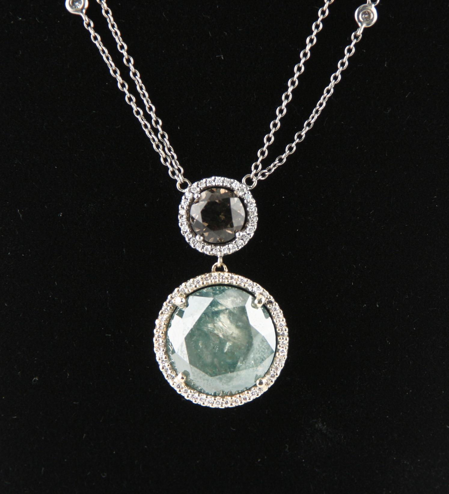 Amazing, Unique Diamond Solitaire Pendant
Features 11.46 carat Round Cut Solitaire Diamond Set in Diamond Bezel
Approximately 14 mm in Diameter
Heavily Included Center Stone Has Unique Blue-Green Color with Opalescent Accents
Light Brown Diamond set