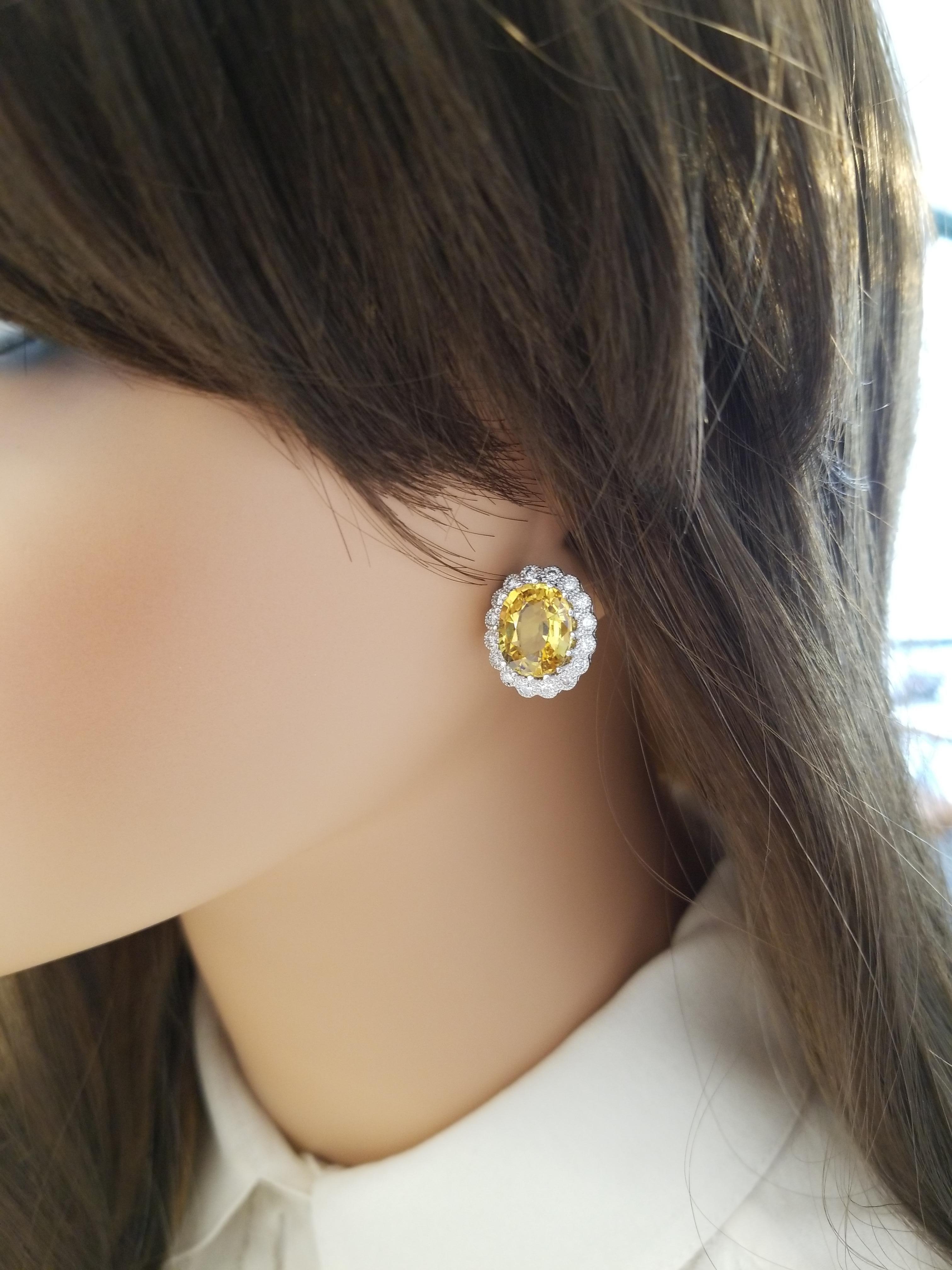 Like drops of golden sun, these magnificent yellow sapphire and diamond earrings brighten up your look. The striking and versatile studs feature perfectly matched 11.24 carat total weight of warm, deeply saturated natural yellow sapphire. The gem