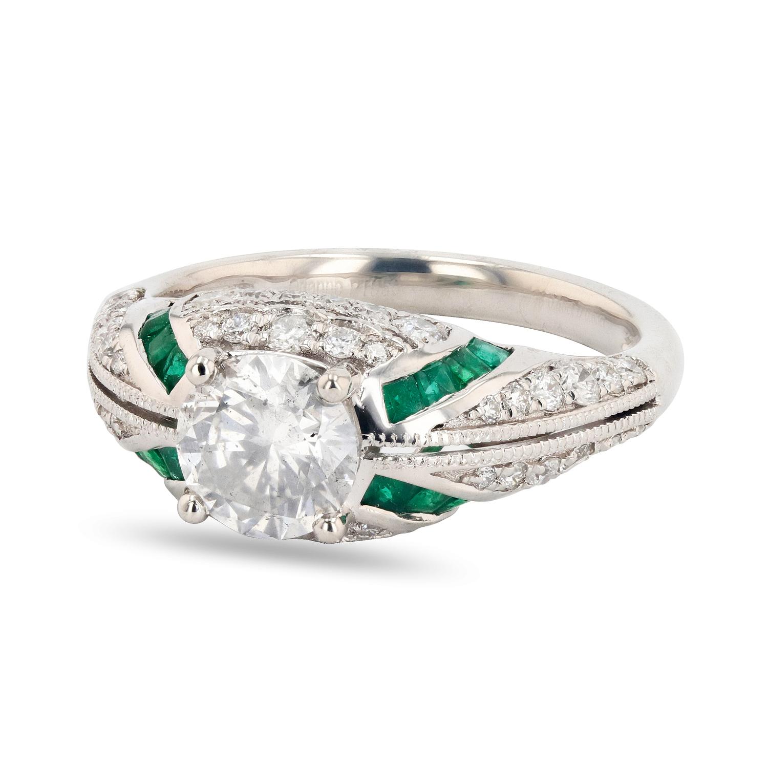 Platinum Diamond & Emerald Ring 
One polished, stamped, and tested platinum ring with a bright finish. The ring is mounted with 1 genuine diamond center stone weighing approximately 1.14 carat, 16 genuine faceted emeralds weighing approximately 0.46