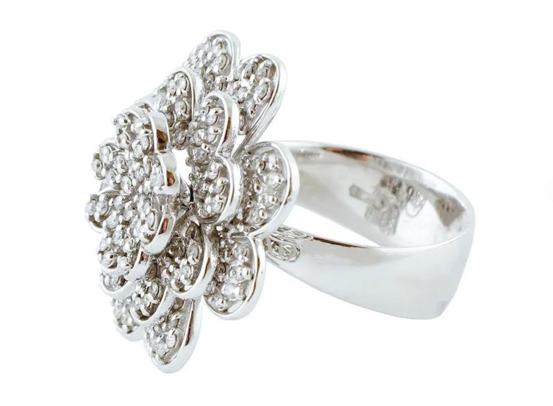Fashion ring in 14k white gold structure, with flower design where all the petals are movable and studded with diamonds. 
This ring is totally handmade by Italian master goldsmiths
Diamonds 1.14ct, round cut, G color, VS clarity
total weight