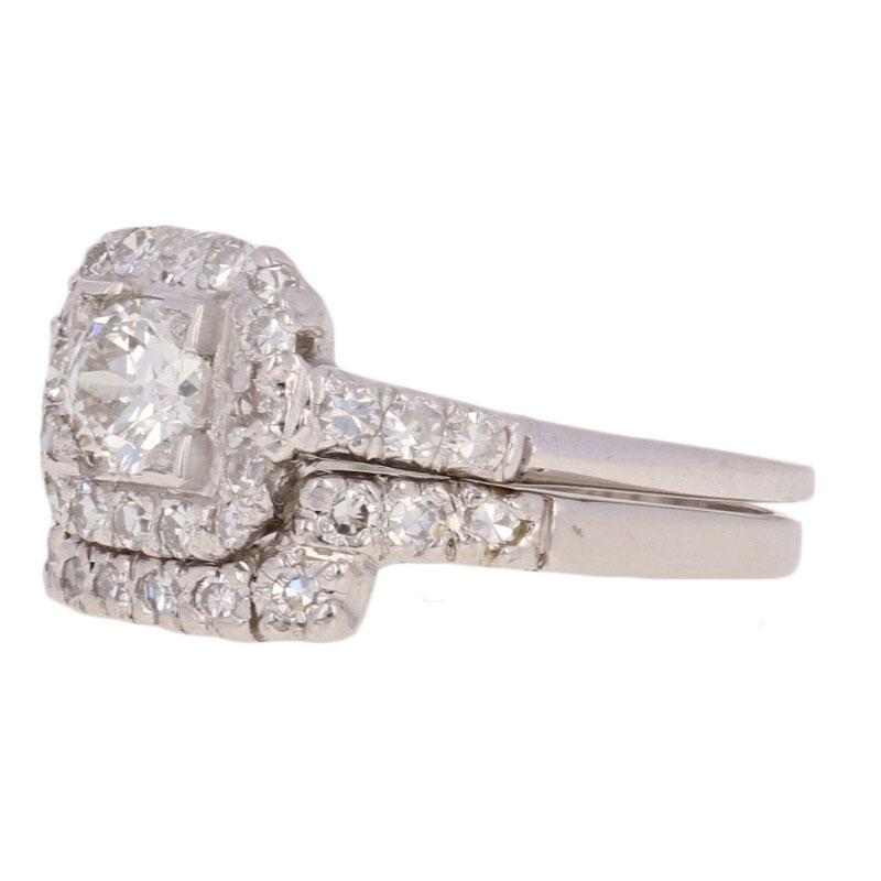 Art Deco splendor! Dating back to the 1930s - 1940s, this platinum bridal set showcases a halo engagement ring and a matching guard-style enhancer wedding band that are both adorned with sparkling white diamonds.  

These rings are a size 7 1/4, but