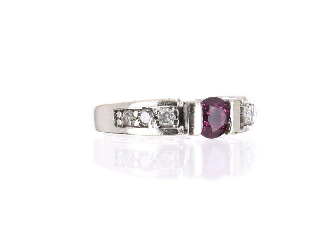 Displayed is a gorgeous contemporary pink tourmaline and diamond ring. This is quite an alluring piece with a stunning center stone! The center gem is a AAA+ quality rubellite that is hand set in 14K white gold. This stone is beautifully saturated