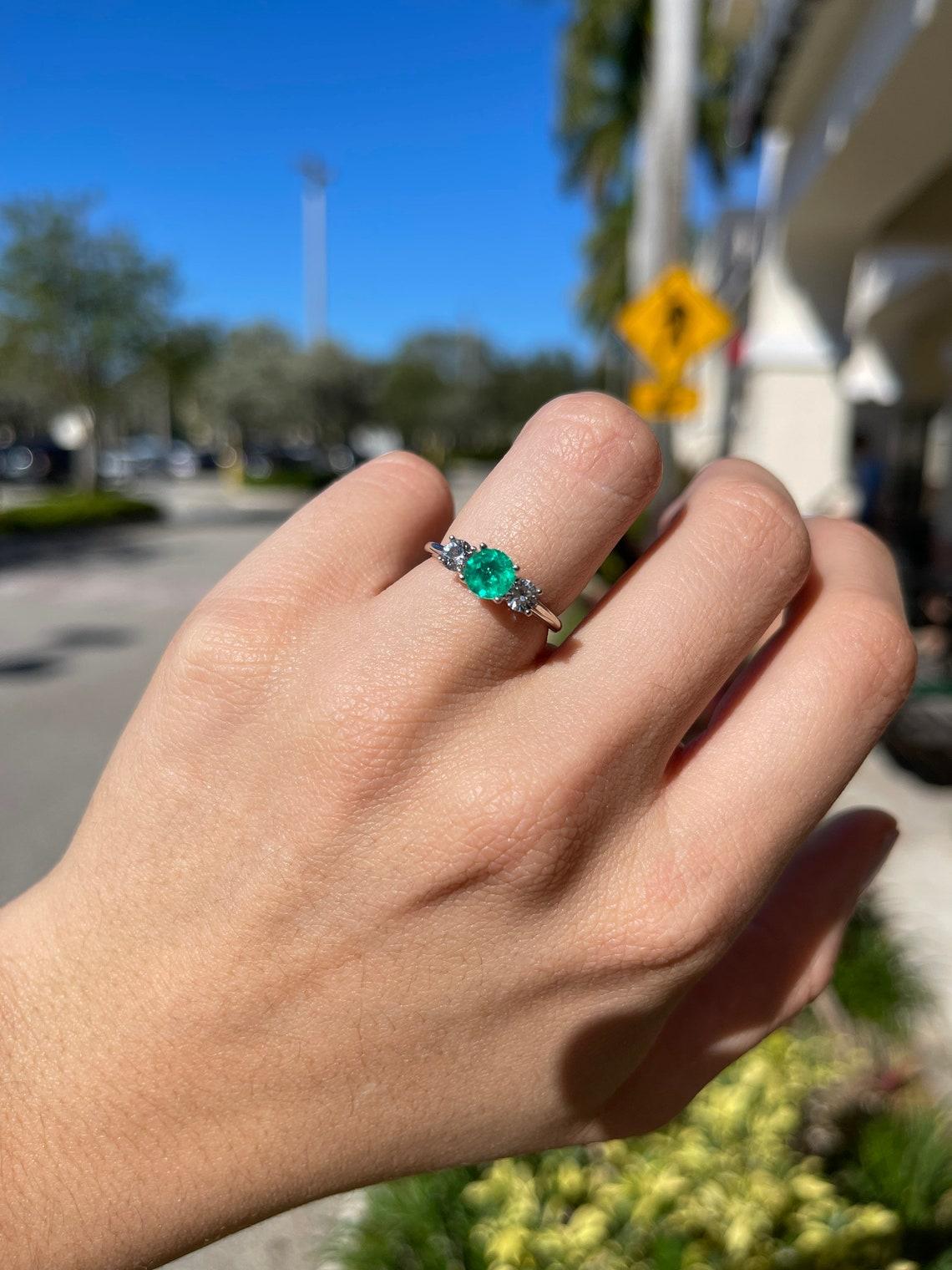 three stone engagement ring emerald
