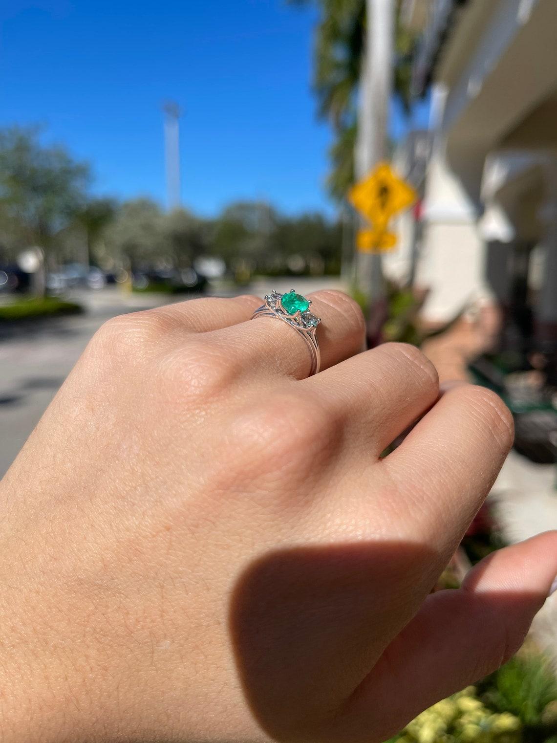 three stone emerald engagement ring