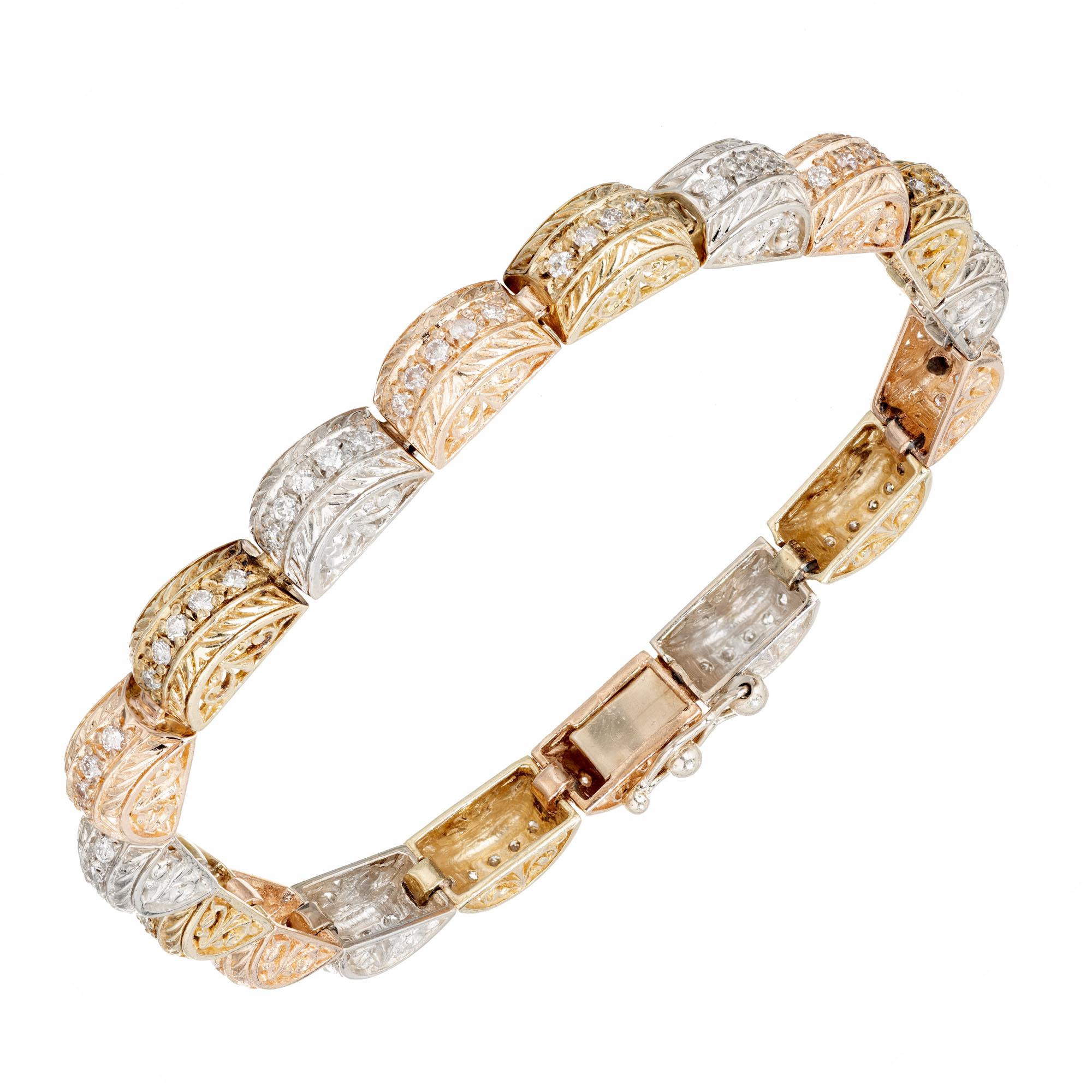 Hinged domed link bracelet with pierced sides and engraved tops. Tri-color 14k yellow, Rose and white gold. 

89 full cut diamonds, approx. total weight 1.15cts, F, VS2 to SI1 
Length: 7 inches 
Width: 5.46mm 
Height: 5.2mm 
Hand engraved and bead