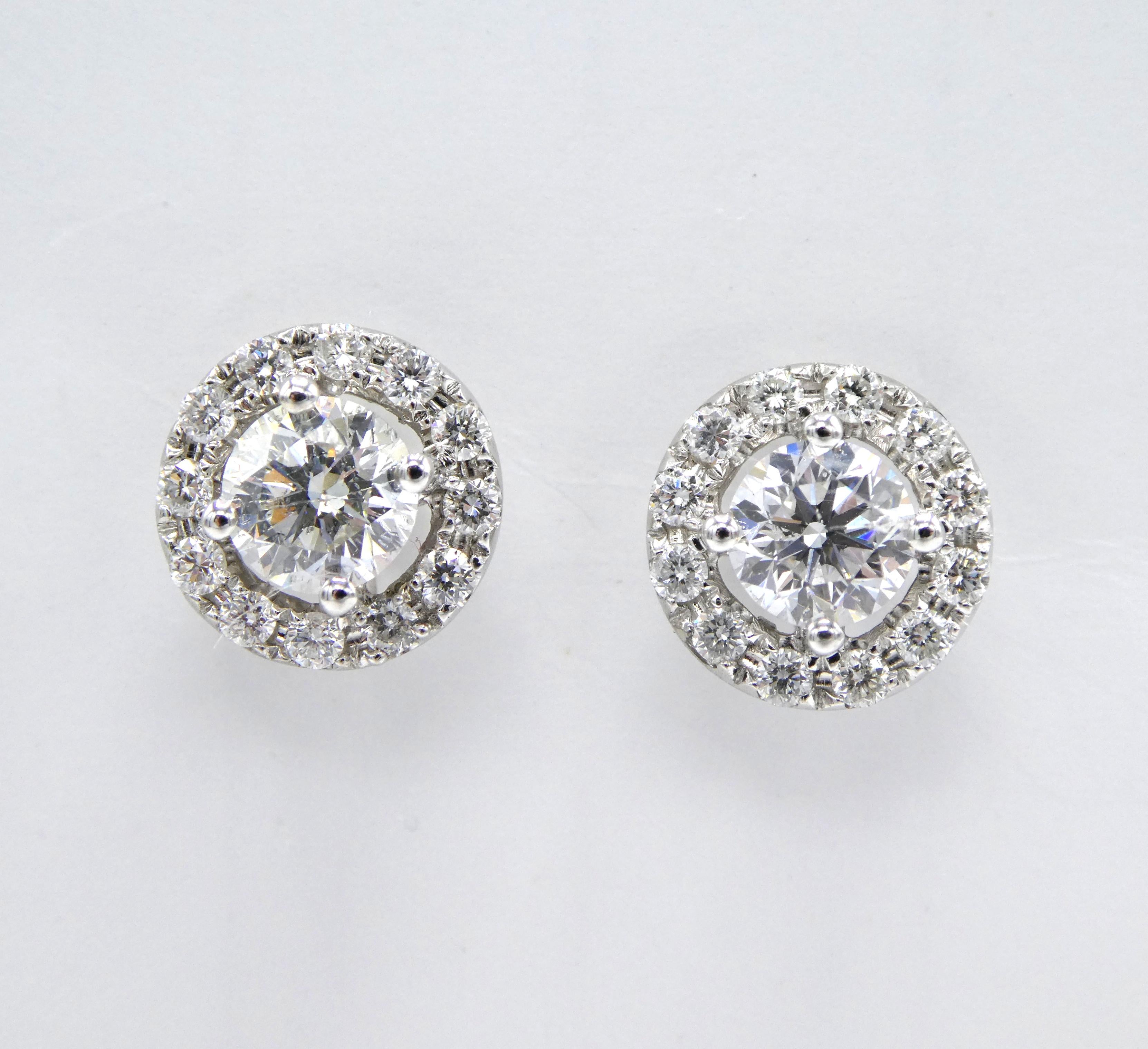Vintage 14K White Gold Diamond Halo Stud Earrings 1.15CTW

Metal: 14k white gold
Weight: 2.94 grams
Diamonds: 2 center diamonds measure 4.7mm (approx. 1/2 carat each), H SI, 24 round brilliant diamonds surrounding, totaling approx. 1.15 CTW H SI