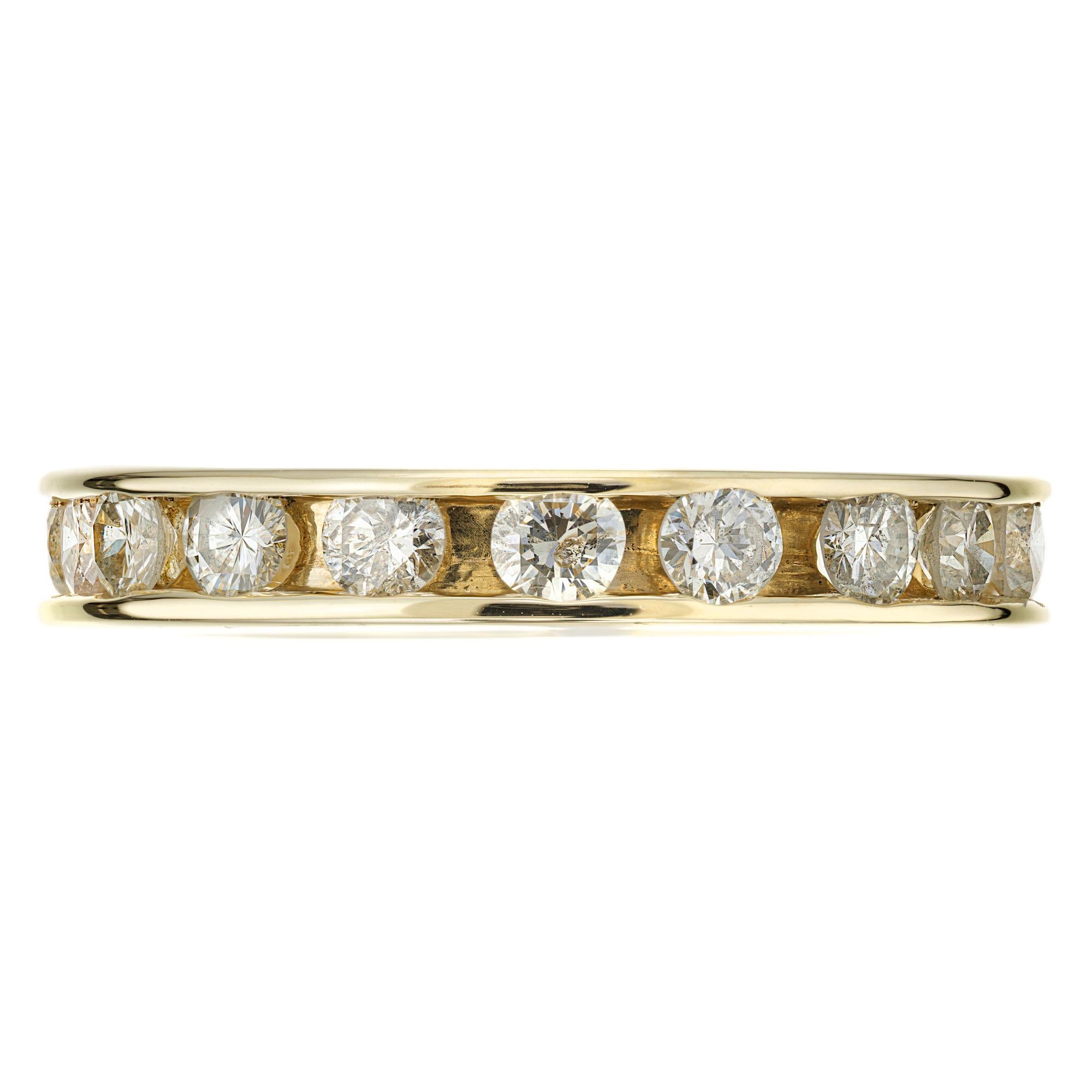 Channel set Diamond Eternity wedding band ring. 19 round full cut diamonds set in a 14k yellow gold setting.  

19 round full cut Diamonds, approx. total weight 1.15cts, I, SI1 – I1
Size 5.75 and not sizable
14k yellow gold
Tested: 14k
3.6