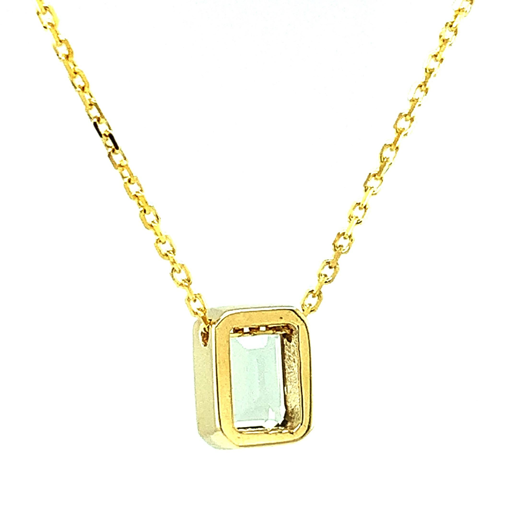 This understated necklace will add a touch of sparkle to any outfit! An unusual pale gray-blue emerald-cut topaz has been set in a shiny 18k yellow gold bezel and hangs from an 18-inch, 18k yellow gold chain. It can be worn alone or layered with