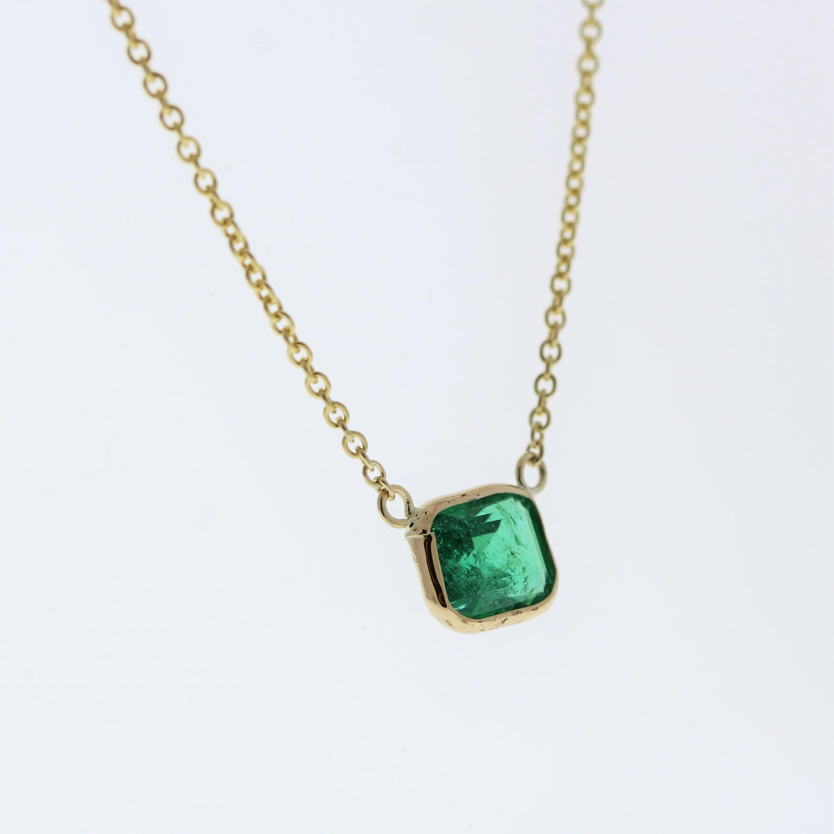 The necklace features a 1.15-carat emerald-cut emerald set in a 14 karat yellow gold pendant or setting. The emerald cut and the lush green color of the emerald against the yellow gold setting are likely to create an elegant and eye-catching fashion