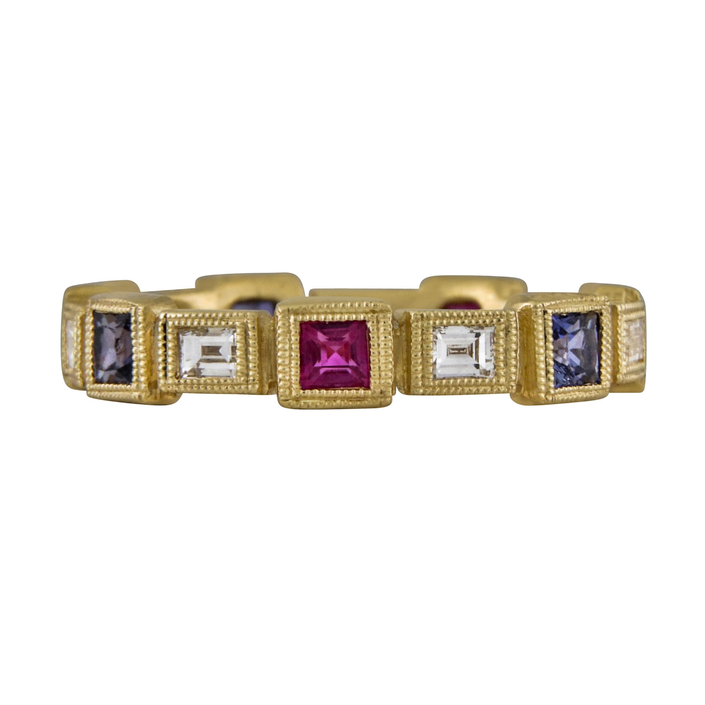 Featured is a hand crafted 18 karat yellow gold diamond & sapphire ring with 6 baguette diamonds weighing 0.35 carats with 3 red rubies and 3 blue sapphires weighing 0.80 carats 4.70 grams finished with a mill grained trim and a lightly brushed