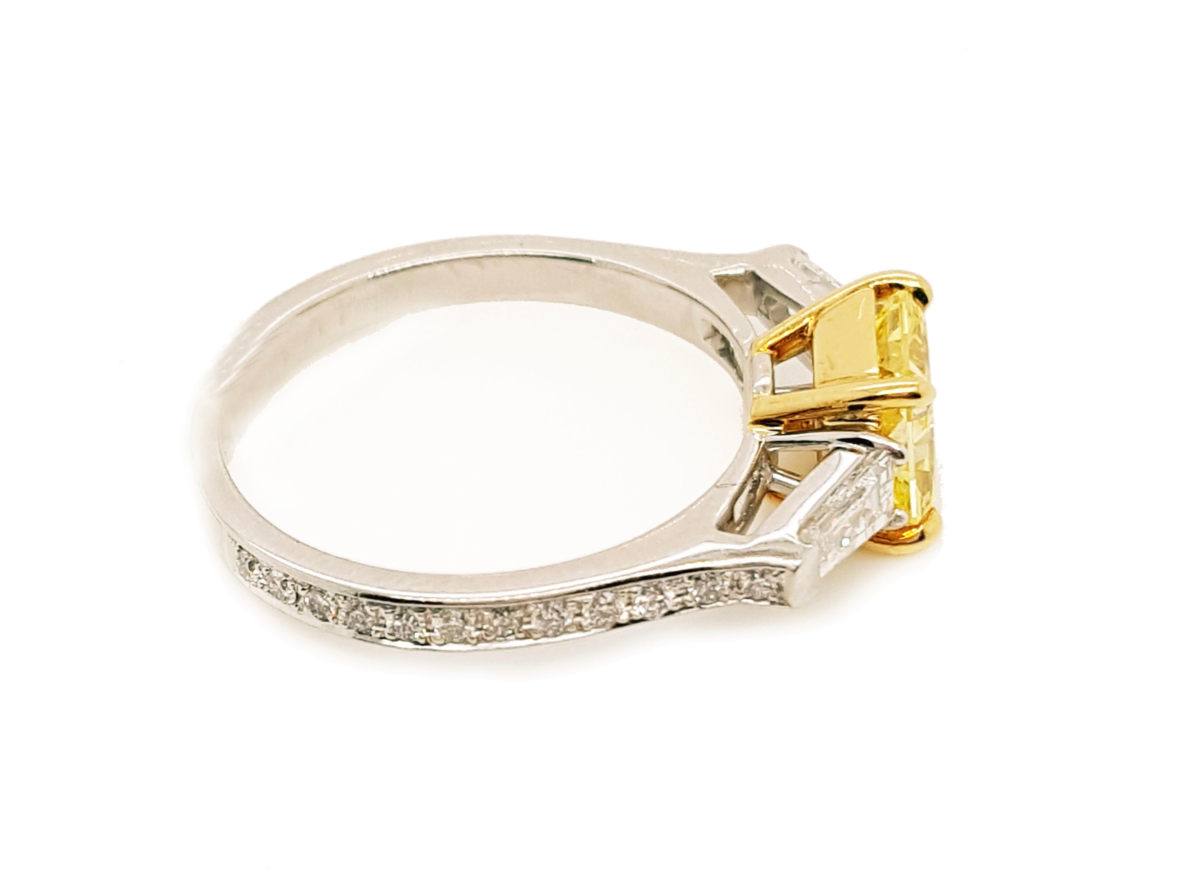 Absolutely stunning engagement ring style showcasing a Fancy Vivid Yellow 1.18 carat radiant cut diamond certified by GIA as SI1 clarity. Flanked by two Tapered baguette cut diamonds total weight 0.44 carat. Surrounded by 24 round brilliant white