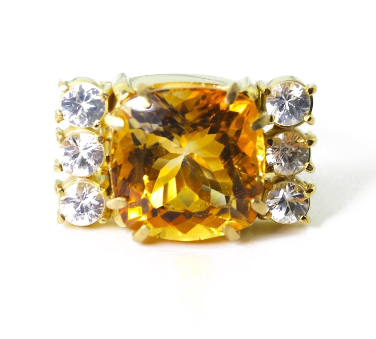 This sparkling multi-color flashes of goldy yellow 11.5 Carat Citrine (13.8 mm x 13.8 mm) is enhanced with approximately 1.2 Carats of brilliant white Sapphires set in a unique handmade 18 Kt yellow gold. The ring is a size 7 (sizable).  This is a
