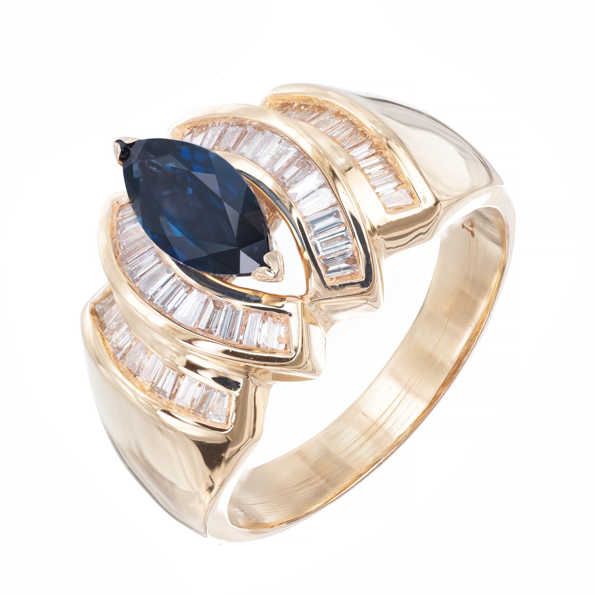 1960's Marquise sapphire and diamond cocktail ring. Marquise center sapphire with 42 baguette accent diamonds in a 14k yellow gold setting. 

1 marquise cut sapphire 1.15ct.
42 baguette diamonds approx. total weight .50ct, G, VS.
Size 9.5 and