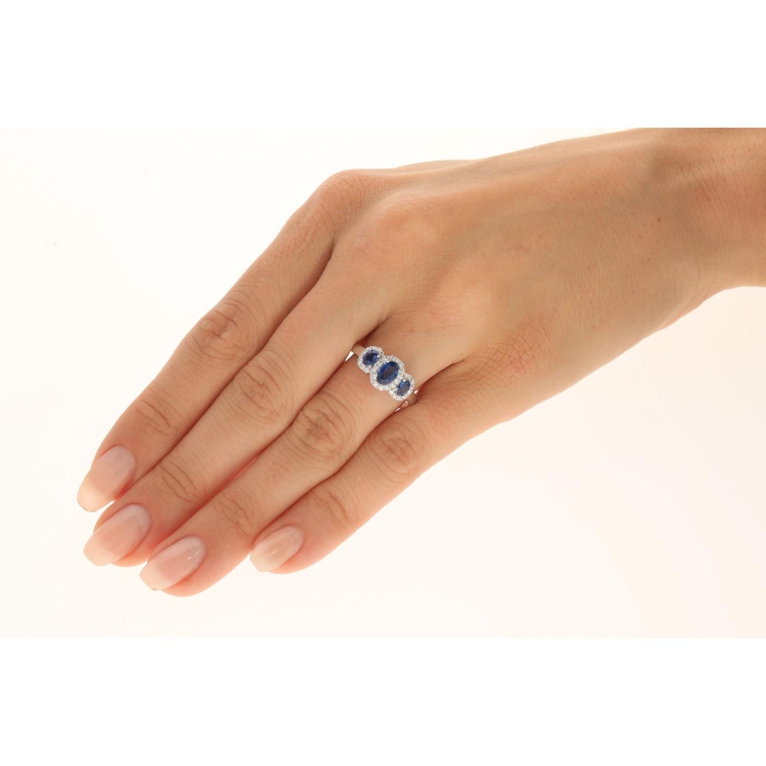 Decorate yourself in elegance with this Ring is crafted from 14-karat White Gold by Gin & Grace. This Ring is made up of 6x4 mm Oval-Cut (1 pcs) 0.60 carat, 3x4 mm Oval-cut (2 pcs) 0.54 carat Blue Sapphire and Round-cut White Diamond (32 Pcs) 0.26