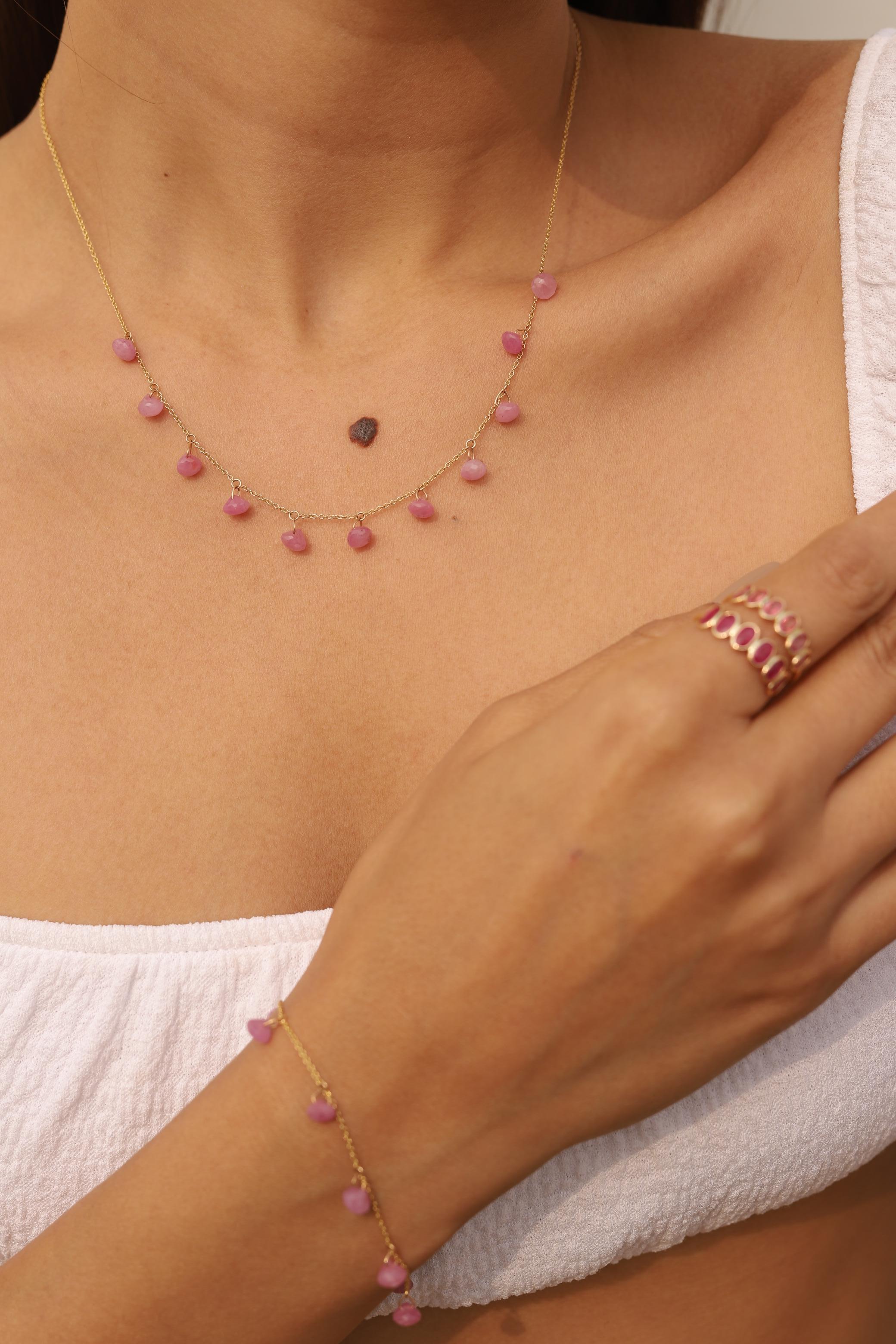 Pink Sapphire Necklace in 18K Gold studded with drop cut sapphire pieces.
Accessorize your look with this elegant pink sapphire drop necklace. This stunning piece of jewelry instantly elevates a casual look or dressy outfit. Comfortable and easy to