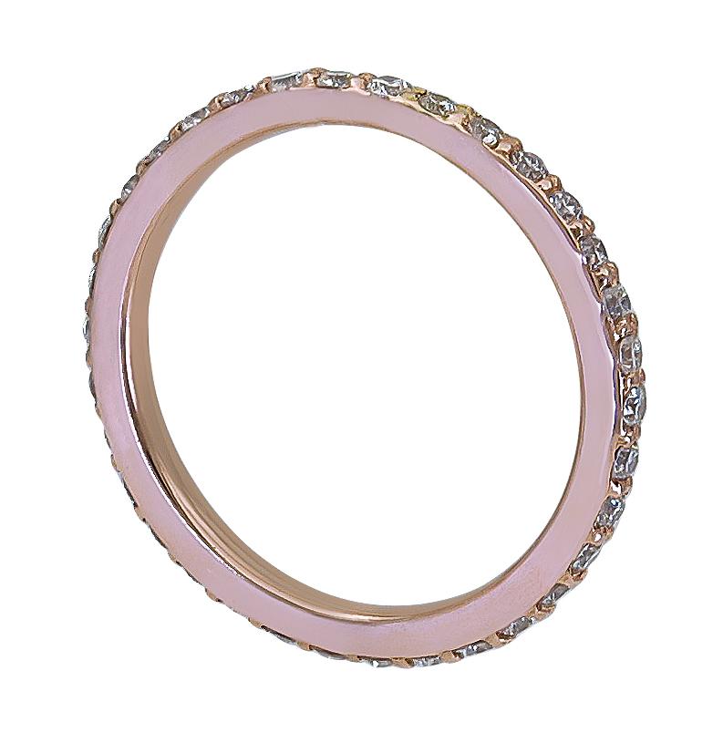 A classic eternity wedding band showcasing a row of round brilliant diamonds, set in polished 18k rose gold. 
Diamonds weigh 1.15 carats total.
Size 5.5 US.
0.15 cm width.