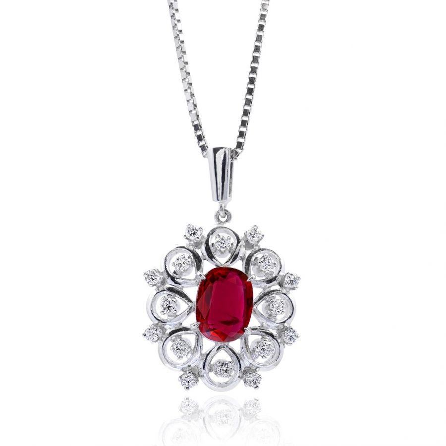 At the heart of this pendant lies a vibrant, fiery crimson center stone, embodying energy and passion. The 1.15 carats Ruby, cut in an elegant oval shape, brings this pendant to life. To enhance its vivid color, the Ruby has been carefully heated,