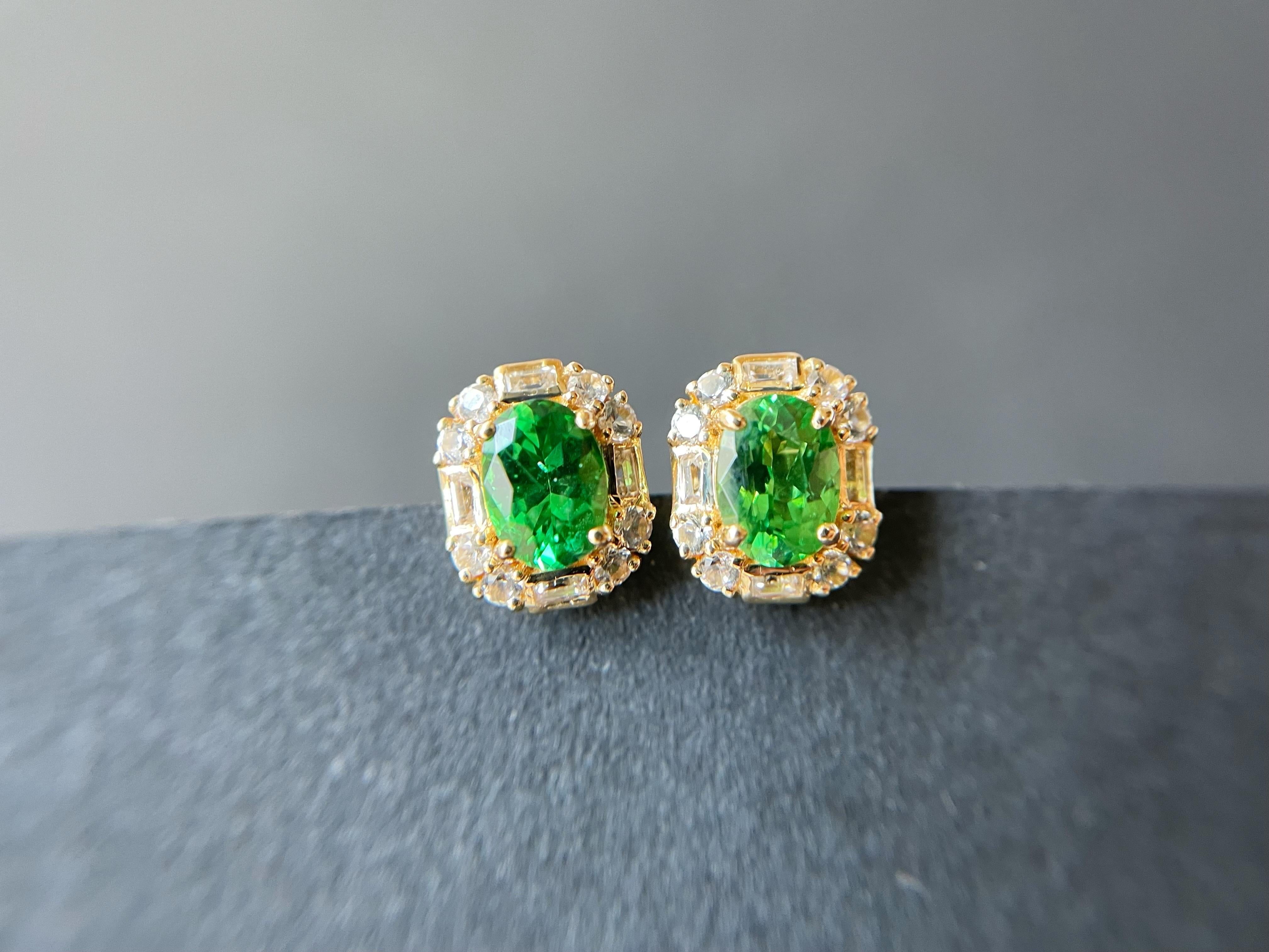 A pair of stunning natural vivid green tsavorite ear studs are set in 18K gold and white sapphires.  A timeless and simple style is a great addition to your jewelry collection that you can wear with something casual or elegant all year long.  These