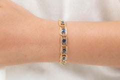 Bracciale tennis con diamanti e zaffiri blu taglio ovale da 11,5 carati in oro giallo 18 carati