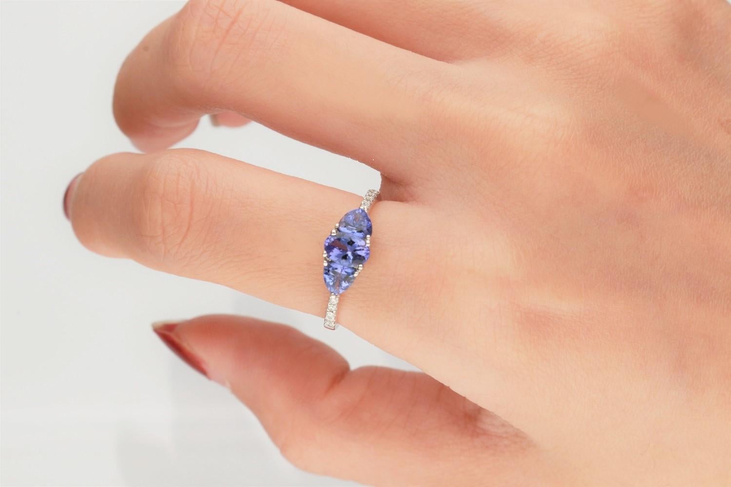 This beautiful three stone Tanzanite Ring is crafted in 14-karat White gold and features 3 Tanzanite weighing to 1.15 carat, 10 Round White Diamonds in GH- I1 quality with 0.07 ctw in a prong-settings. This Rings comes in in sizes 6 to 9, and it is