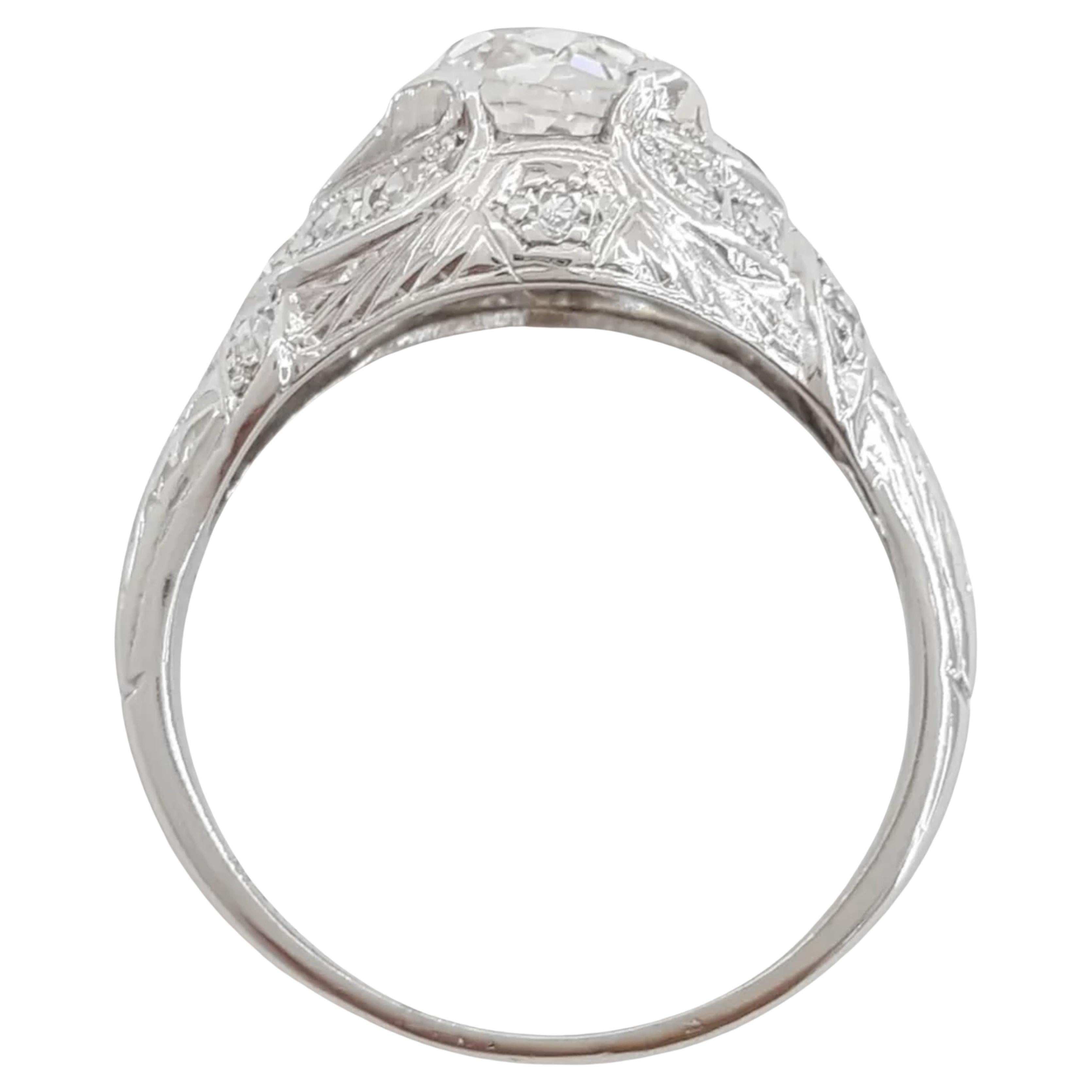 engagement ring is a remarkable piece with both aesthetic and historical value. The center stone is a 1.13-carat Old Mine Cut diamond, characterized by its antique style that predates modern cuts. It is J in color and VS1 in clarity, which indicates