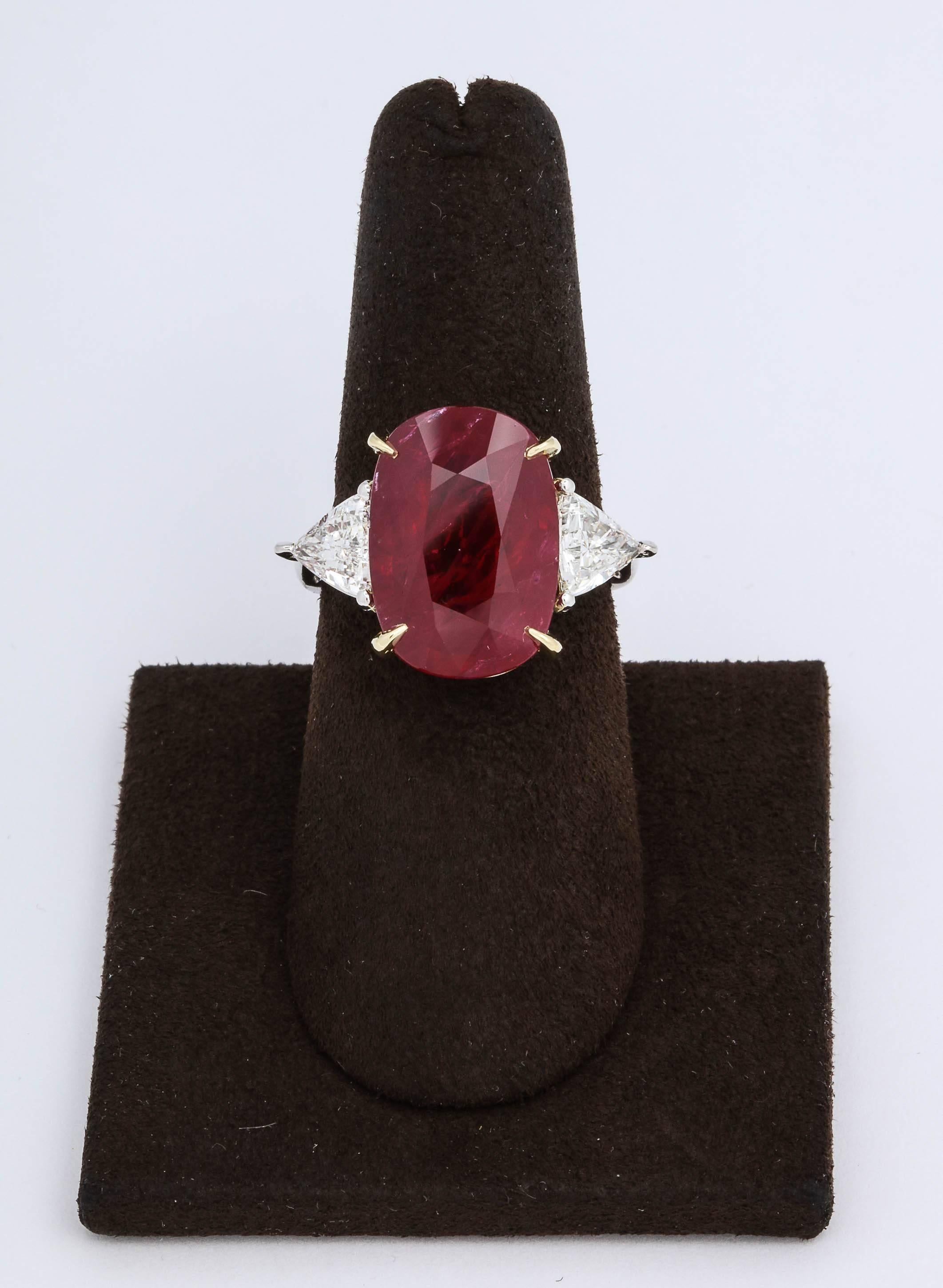 
A stunning center Ruby rich in color, a fantastic ring!

A beautiful elongated cushion cut red ruby.

Set with 1.29 carats of trillion cut diamonds.

The center Ruby measures 16.51 x 11.57 mm -- its a Fabulous shape!

Platinum and 18k yellow