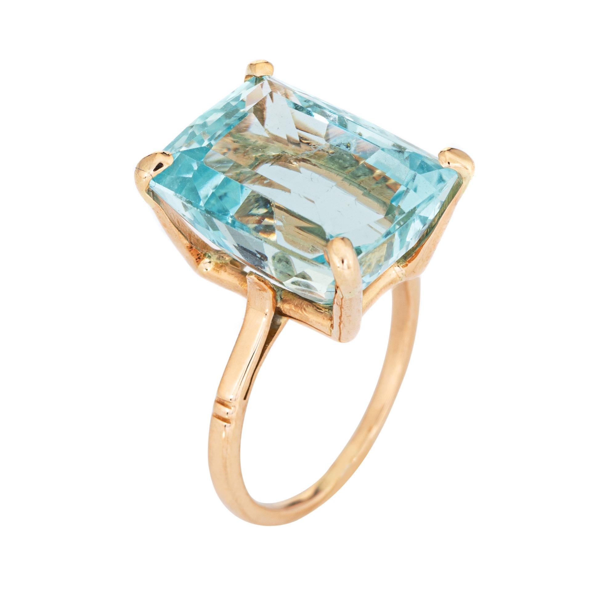Stylish vintage aquamarine cocktail ring (circa 1960s to 1970s) crafted in 18 karat yellow gold with platinum accents. 

Emerald cut aquamarine measures 15.5mm x 11.5mm (estimated at 11.50 carats). The aquamarine is in very good condition and free