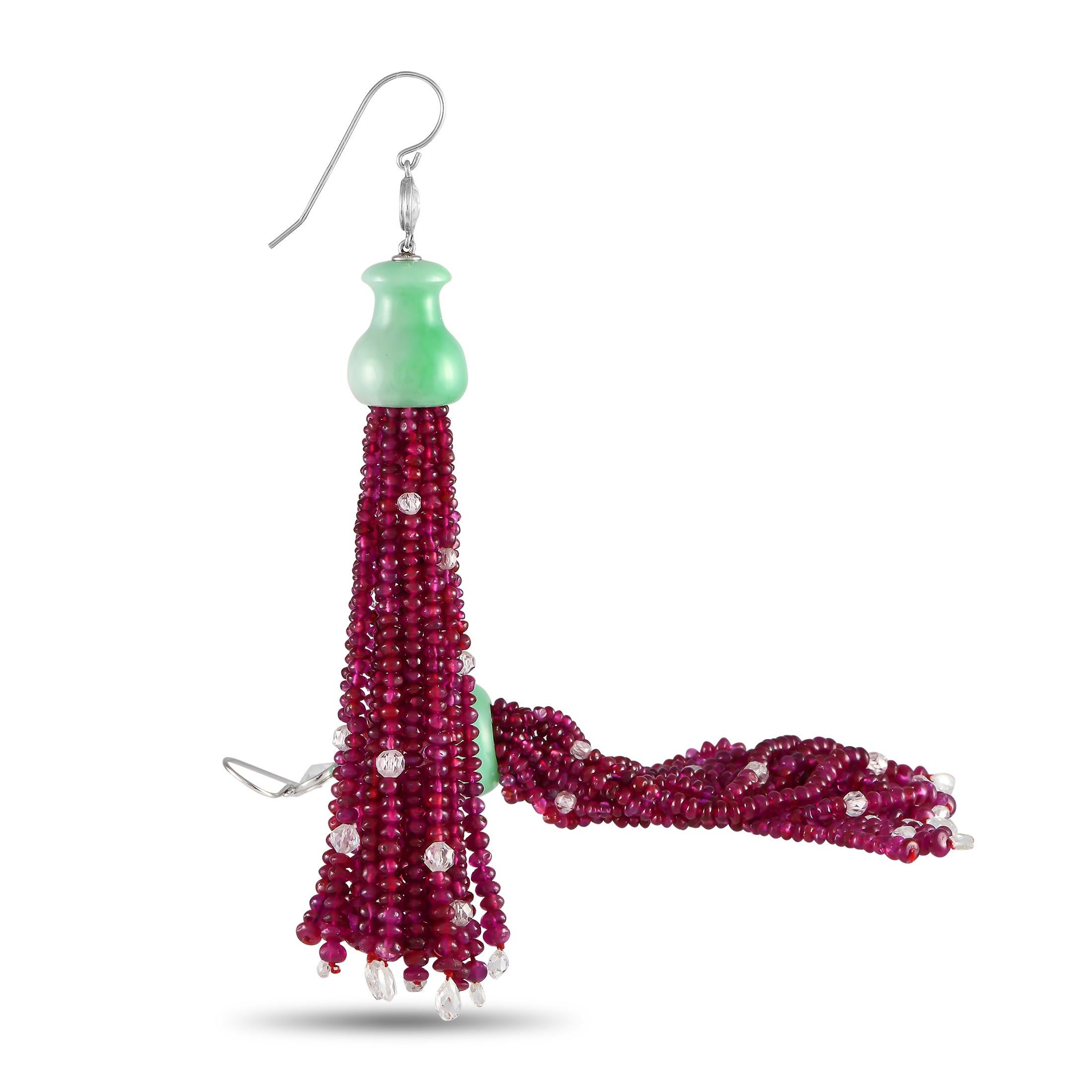 Steal the show regardless of what you're wearing with these tassel earrings. The pair features bezel-set diamonds with triangular facets connected to shapely jade gemstones from where strings of rubies drop. The ruby tassels carry briolette diamonds