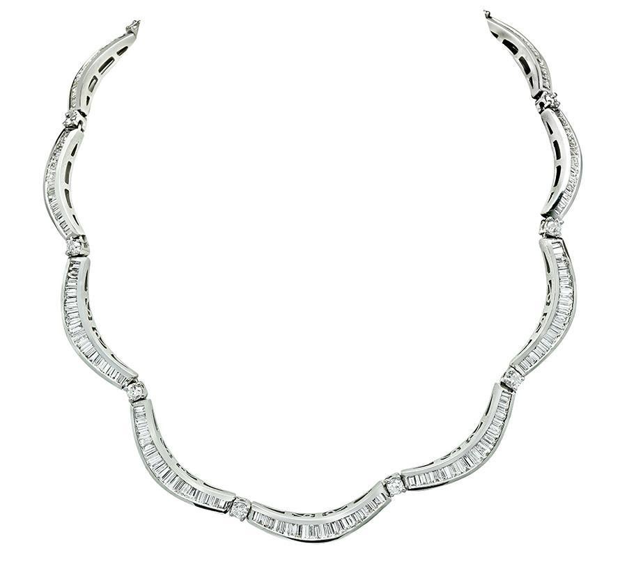 This is an amazing 18k white gold choker necklace. The necklace is set with sparkling baguette and round cut diamonds that weigh approximately 11.50ct. The color of these diamonds is F-G with VS clarity. The necklace measures 15.5 inches in length