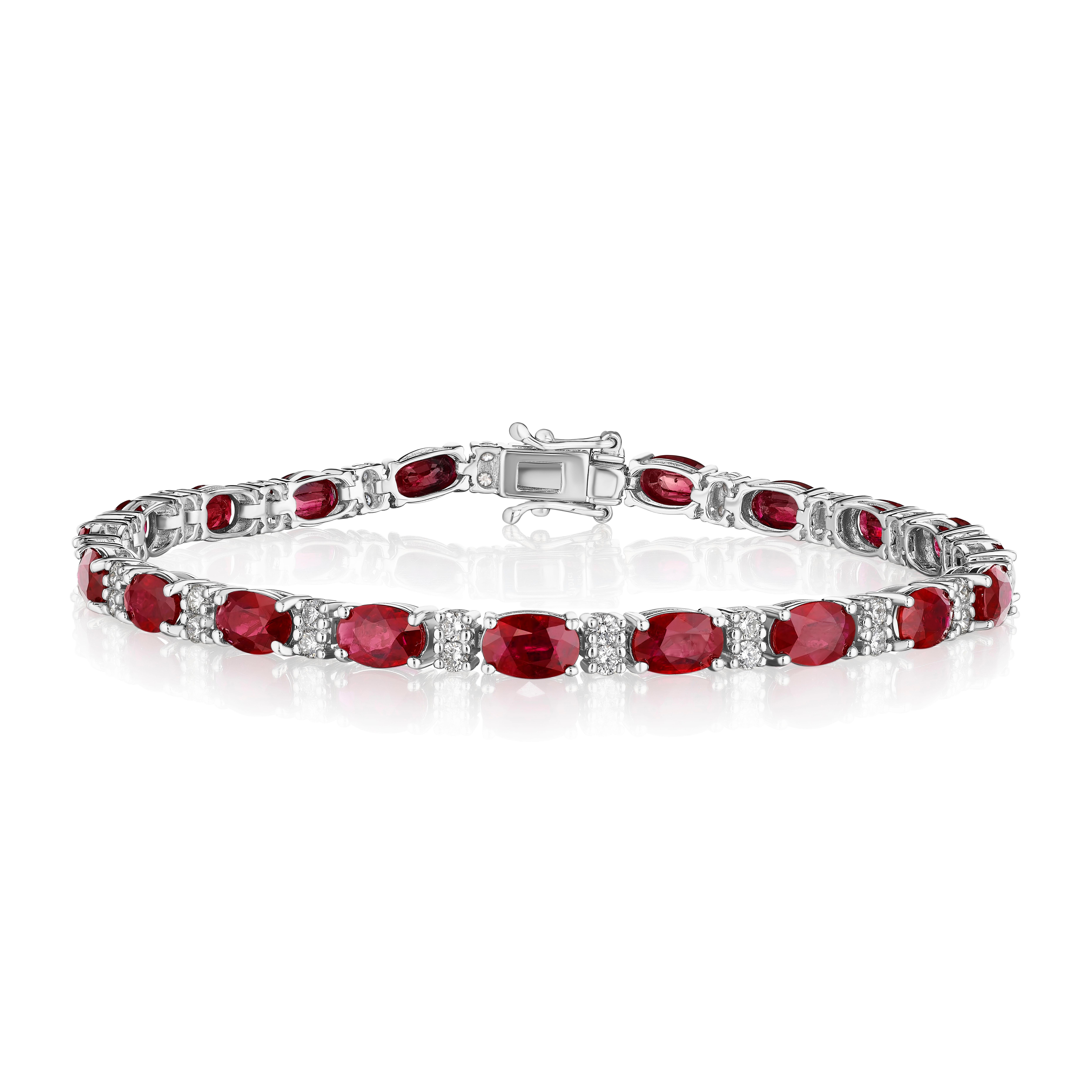 • A beautiful row of red oval cut rubies and white round brilliant cut diamonds encircle the wrist in this bracelet, set in 14KT gold. The bracelet measures 7