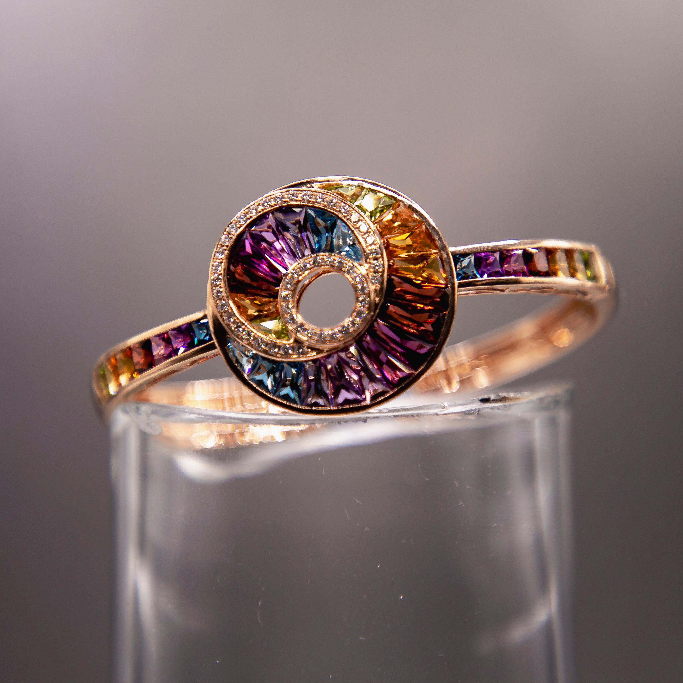 Brilliance and warmth radiate from hand-cut modified baguettes of purple amethysts, burgundy garnets, lemon citrines and blue topazes set in channels in this spectacular handcrafted one of a kind 14 karat rose gold bracelet. The pallet of gems is a