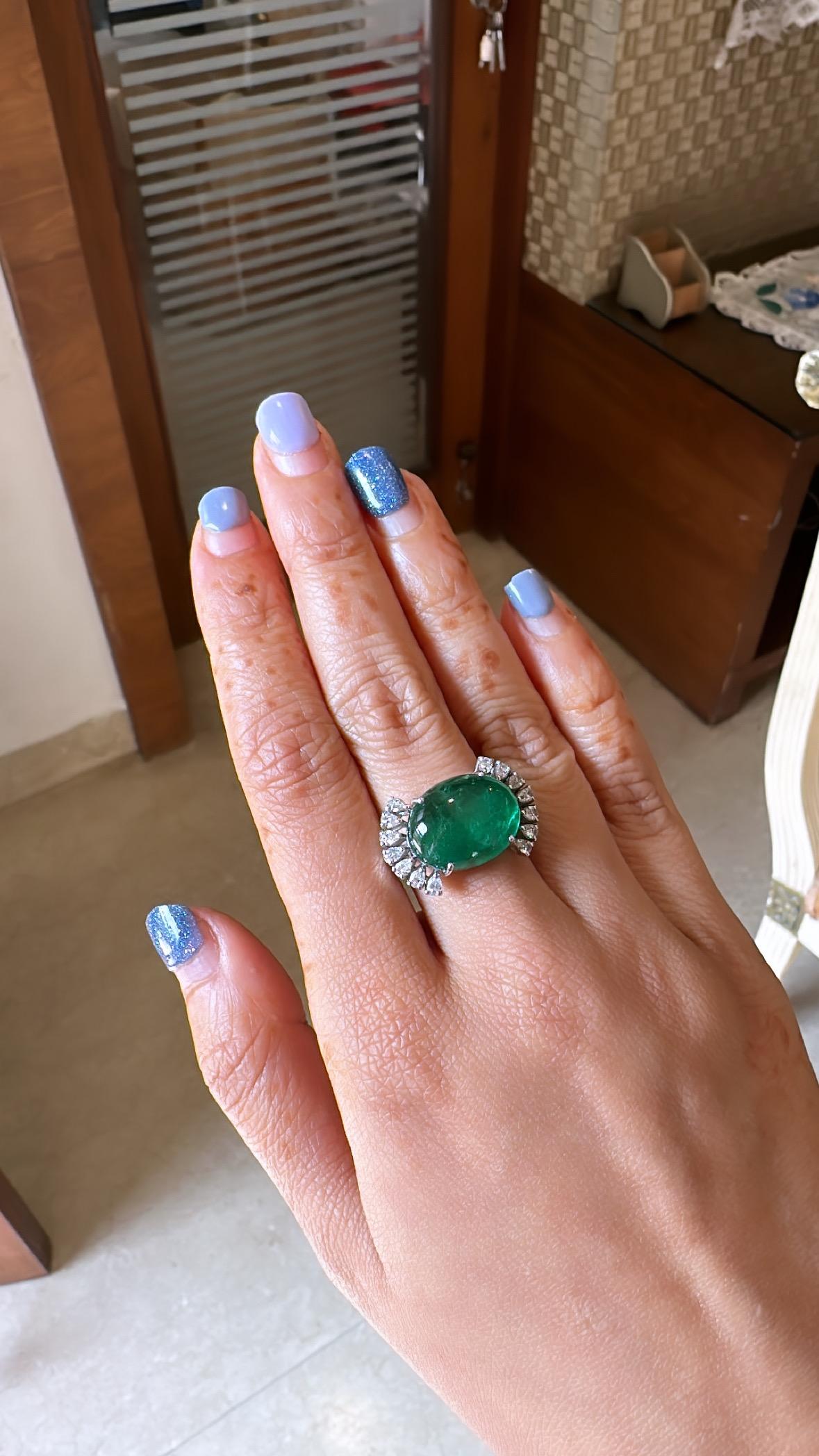 A very gorgeous Emerald Engagement / Cocktail Ring set in 18K White Gold & Diamonds. The weight of the Emerald cabochon is 11.51 carats. The Emerald is completely natural, without any treatment and of Zambian origin. The weight of the Diamonds is