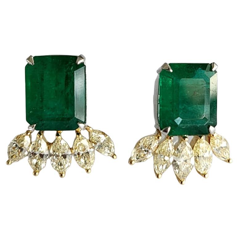 A very gorgeous and modern, Emerald Stud Earrings set in 18K WhiteGold & Yellow Diamonds. The weight of the Emerald pair is 11.51 carats. The Emeralds are completely natural, without any treatment and is of Zambian origin. The weight of the Marquise