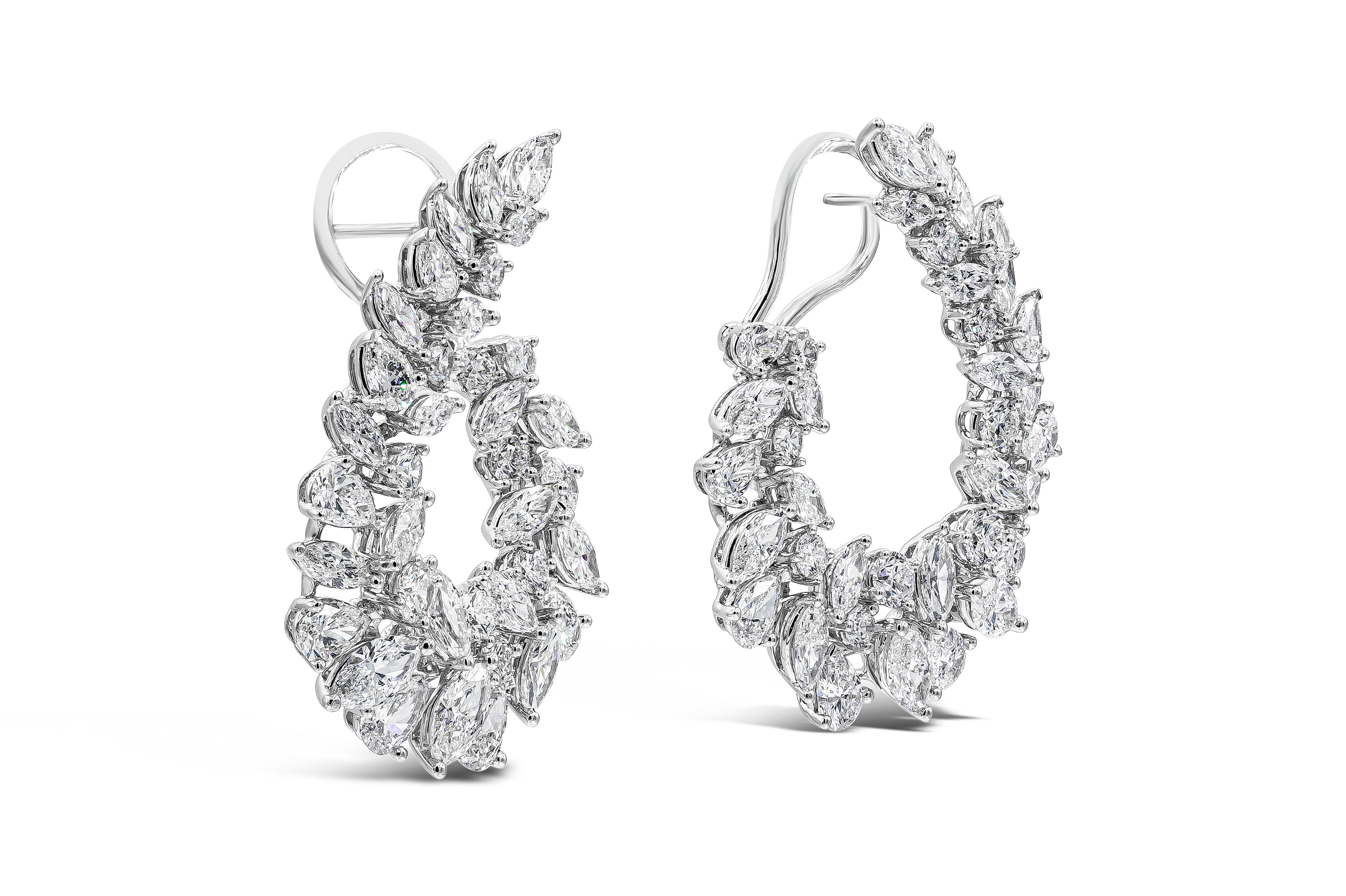 A unique and beautiful piece of jewelry showcasing a combination of brilliant pear shape, marquise and round cut diamonds set in an elegant and intricate wreath design. Diamonds weigh 11.52 carats total and are approximately F-G colors. Earrings