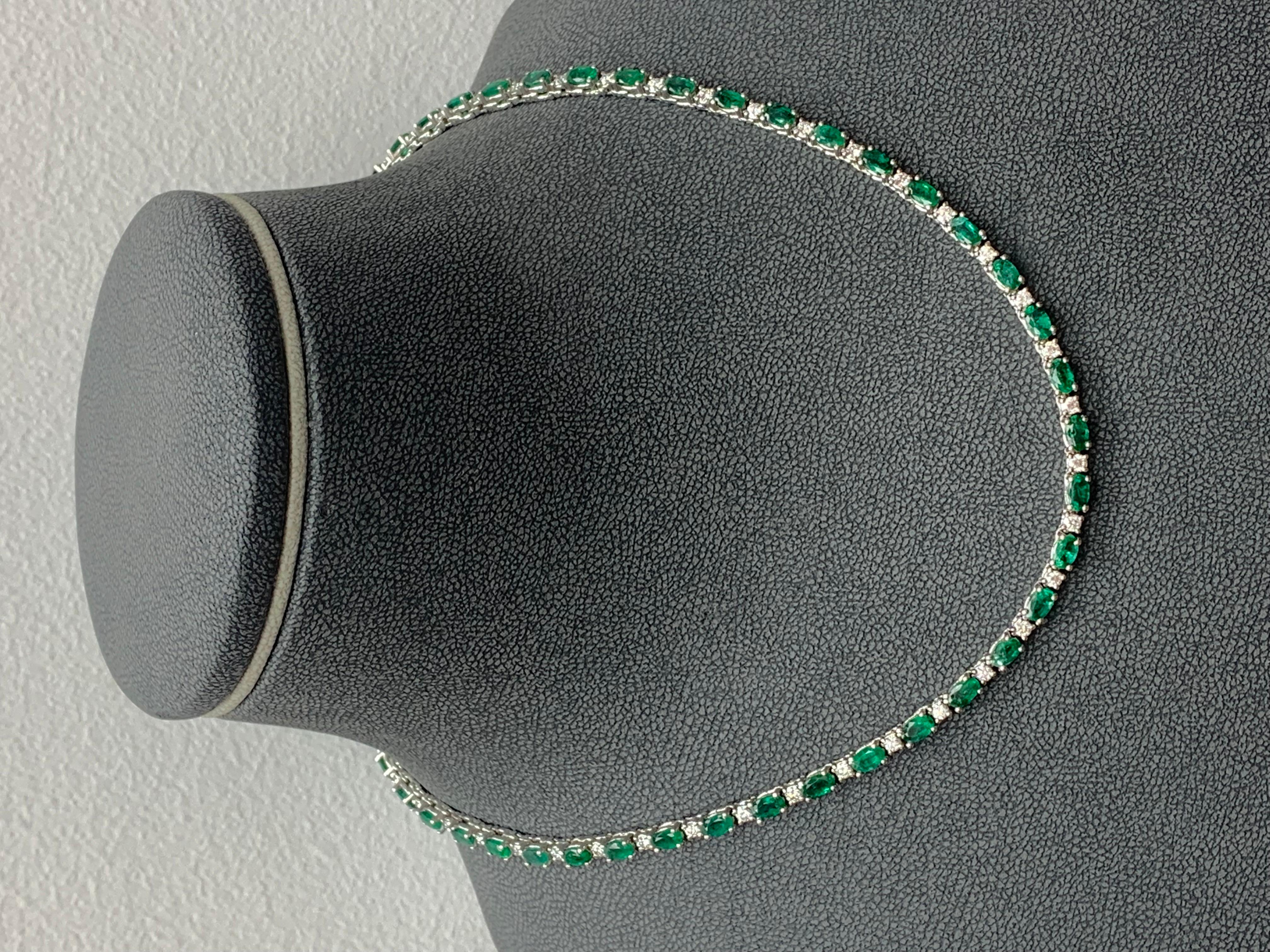 An incredibly color-rich tennis necklace showcasing 11.52 carats of 51 oval-cut lush green emeralds, each elegantly spaced by 51 round brilliant diamonds weighing 2.54 carats total. Made in 14k white gold. Approximately 16 inches in length & can be