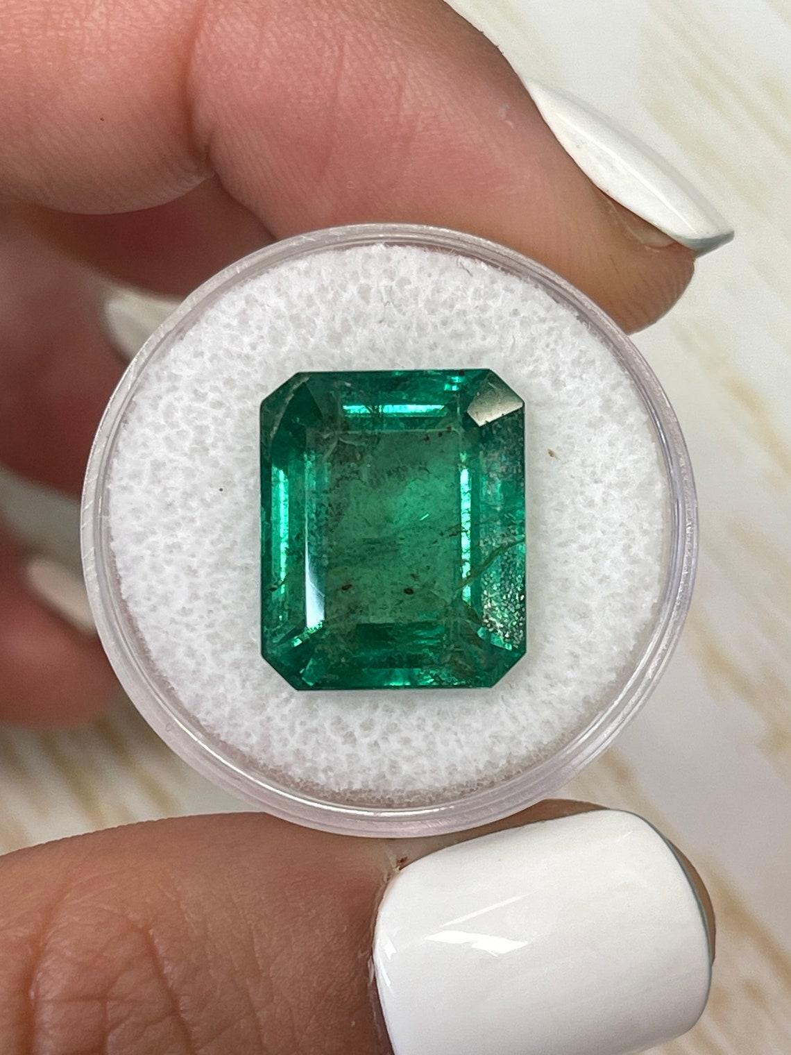 Stone: Emerald
Weight: 11.54-carats
Shape: Emerald Cut
Clarity: Transparent
Luster: Very Good
Color: Medium Green
Measurements: 15.13mm x 12.55mm x 8.07mm
Geographic Origin: Zambia
Treatment: Natural, Oiling

Comments: Due to their growth conditions