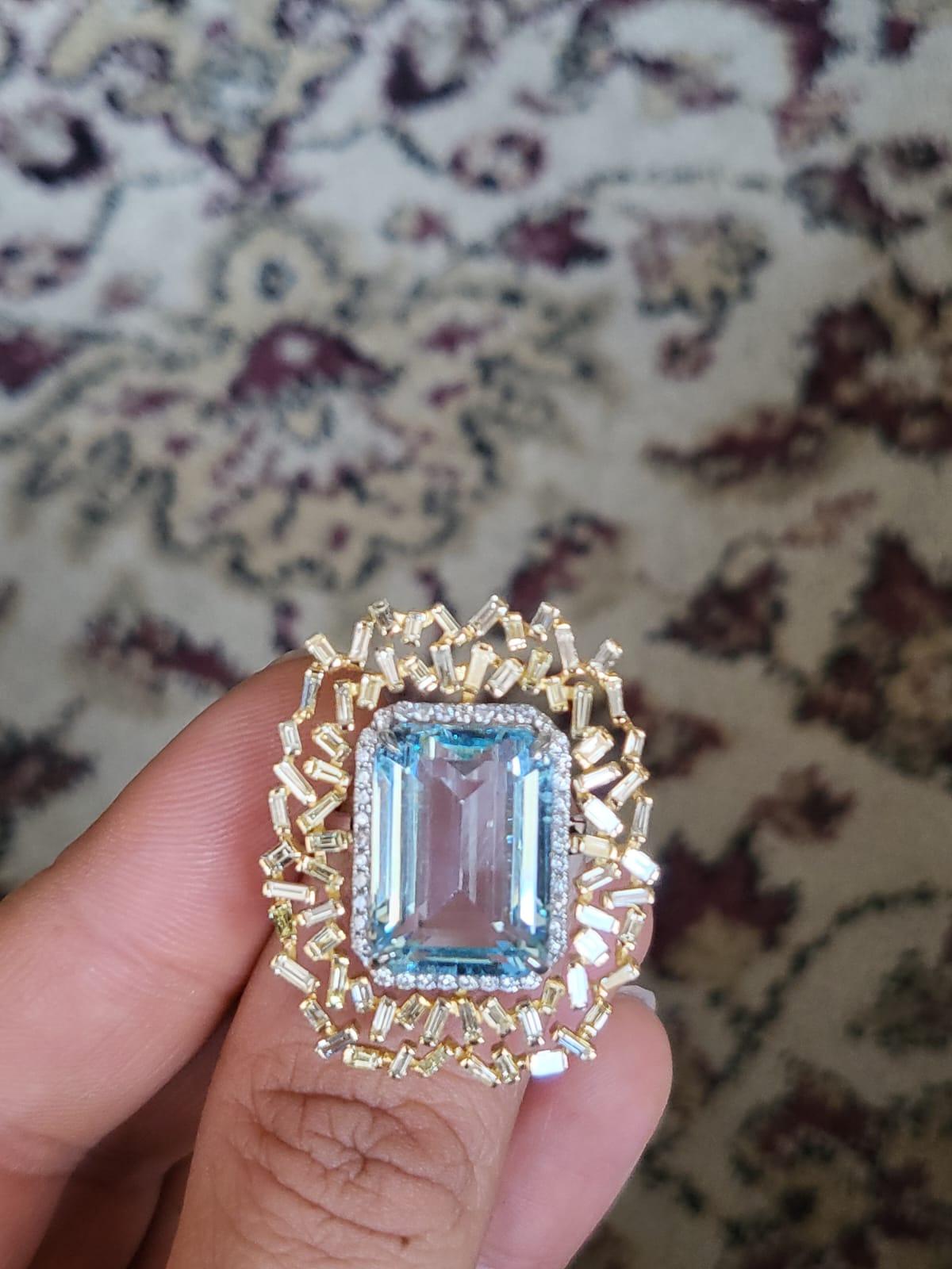 A very gorgeous and classic Aquamarine Cocktail Ring set in 18K White Gold & Diamonds. The weight of the Aquamarine is 11.56 carats. The combined weight of the Diamonds is 1.62 carats. The Yellow Baguette Diamonds is 1.30 carats. Net 18K Gold weight