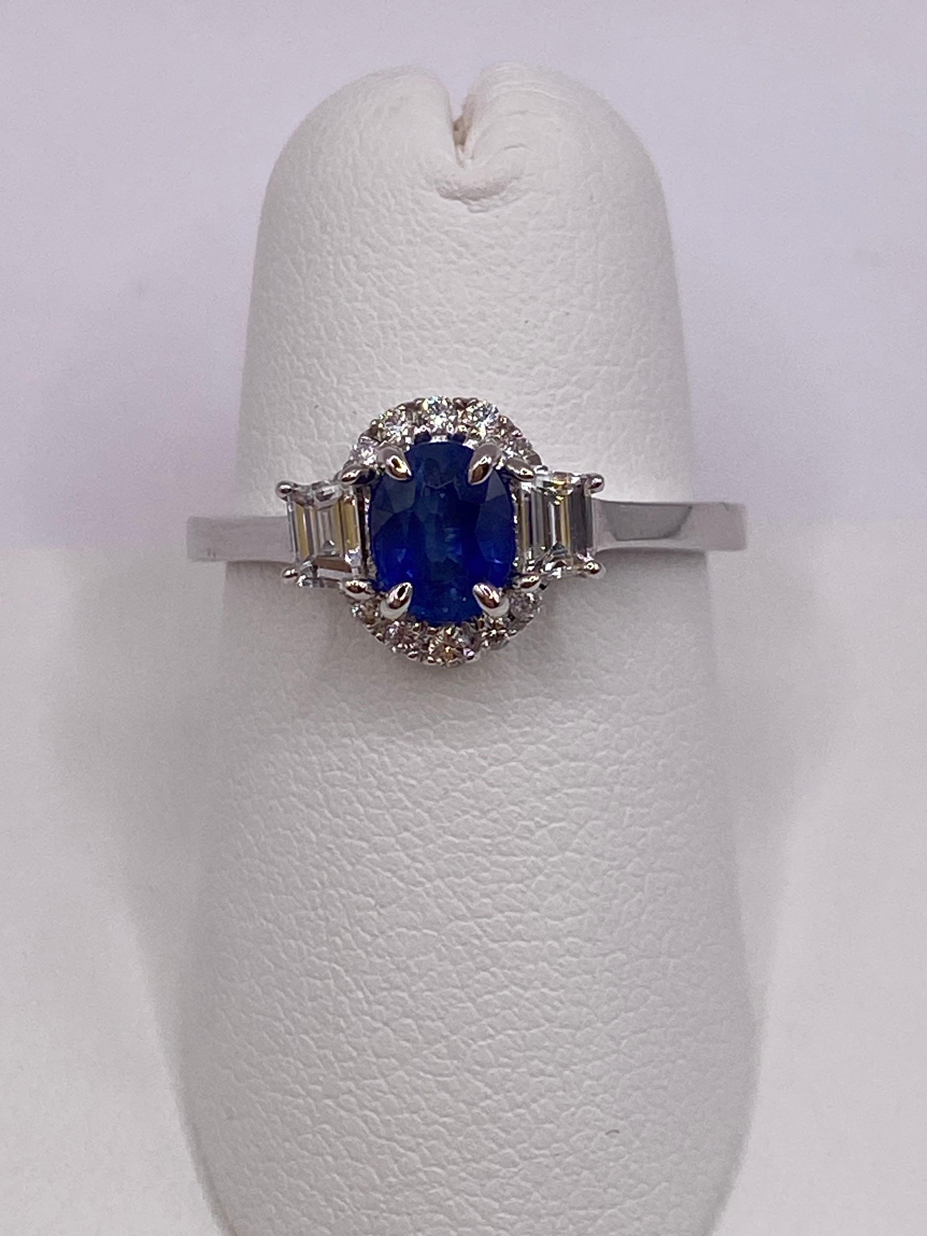 Metal: Platinum
Finger Size: 6.5
(Ring is size 6.5, but is sizable upon request)

Number of Oval Sapphires: 1
Carat Weight: 0.79ctw
Stone Size: 6.0 x 4.5mm

Number of Step Cut Trapezoid Diamonds: 2
Carat Weight: 0.28ctw

Number of Round Diamonds: