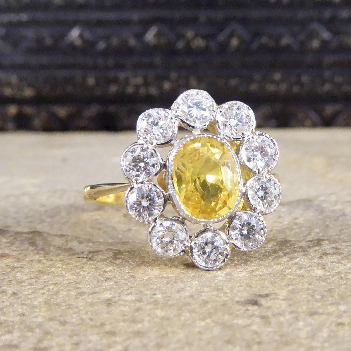 This lovely contemporary Sapphire and Diamond ring has been crafted with a 1.15ct gorgeous and bright Yellow Sapphire centre, surrounded by ten modern brilliant cut Diamonds. Using larger Diamonds in this cluster ring allows there to be spacing