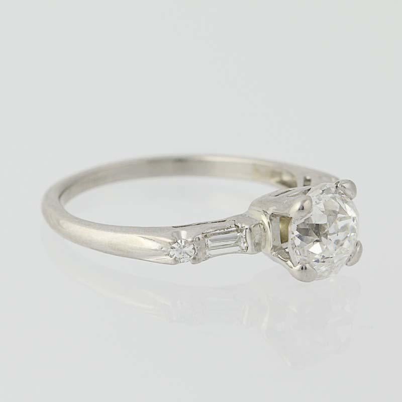The essence of elegance! Fashioned in platinum, a precious metal prized for its strength and enduring beauty, this Art Deco engagement ring from circa 1920’s -1930’s features a exquisite diamond solitaire in a basket-style mounting. Shimmering