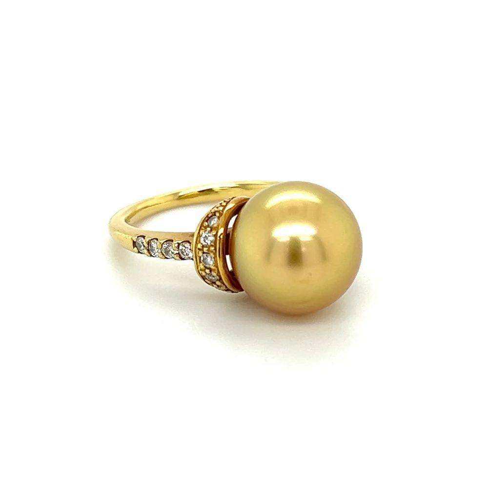 Simply Beautiful! Finely detailed Golden South Sea Pearl and Diamond Cocktail Ring. Centering a securely nestled Hand set 11.5mm South Sea Pearl, enhanced with Hand set Diamonds, weighing approx. 0.23 total carat weight. Dimensions 1.10” l x 0.80” w