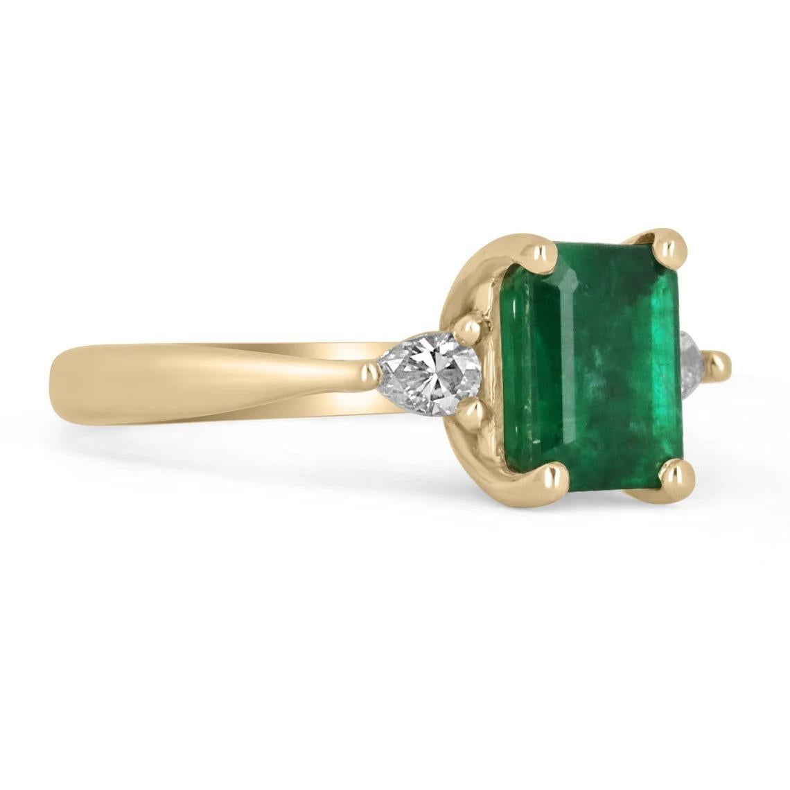 A classic emerald and diamond three stone, engagement, statement, or right-hand ring. Dexterously crafted in gleaming 14K yellow gold this ring features a 3.57-carat natural emerald-emerald cut. Set in a secure prong setting, this extraordinary