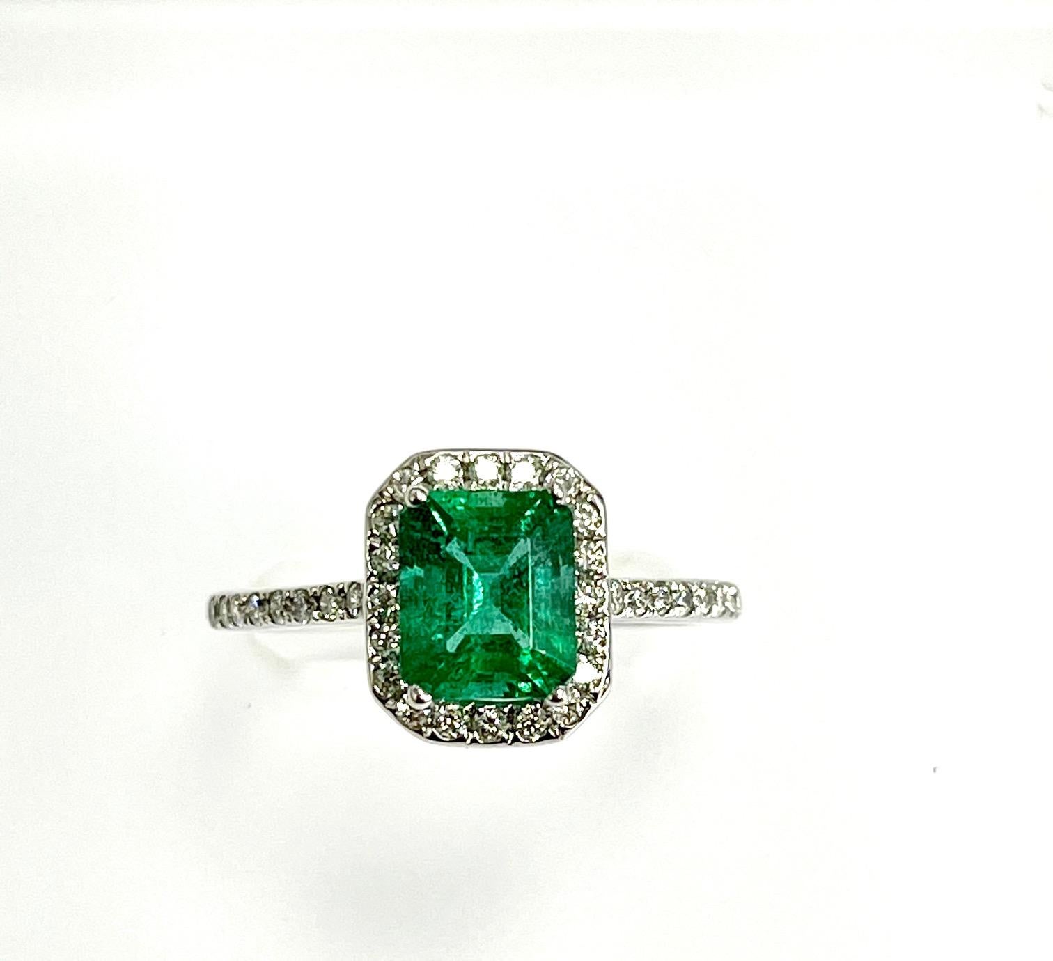 1.16 Carat emerald cut zambian emerald set in 18k white gold ring with 0.32 carat diamonds around it 