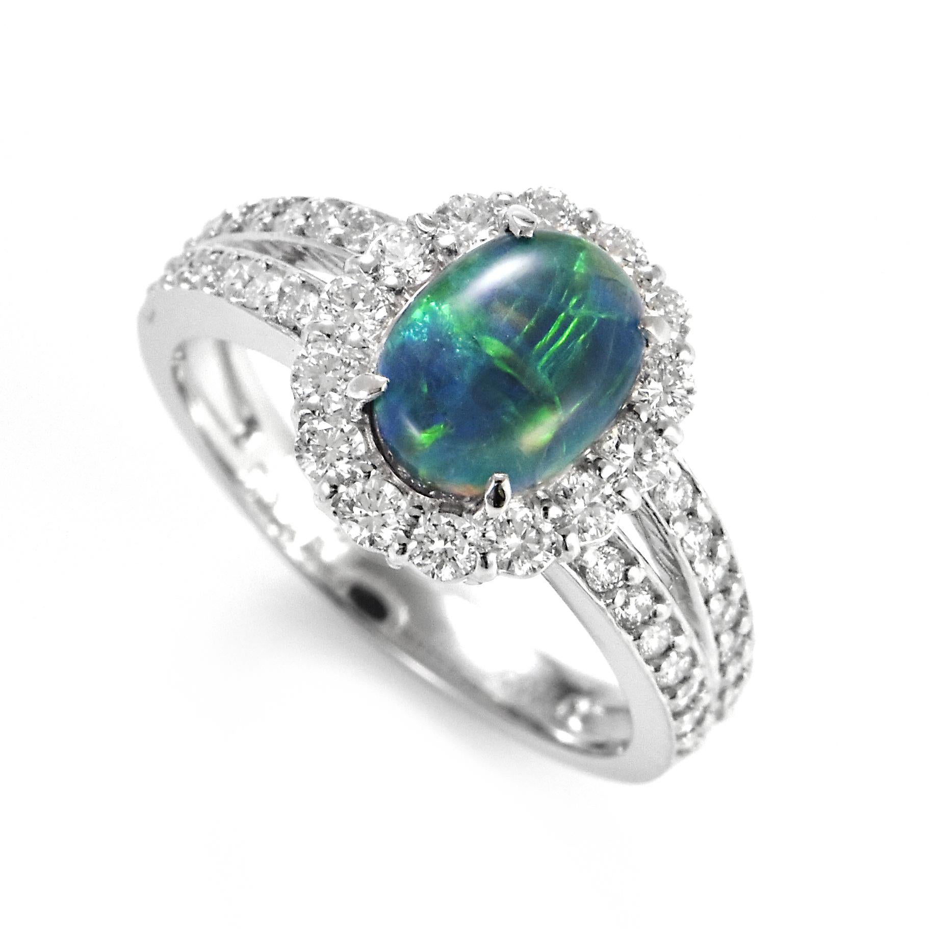 A beautiful ring featuring a 1.164 Carat Australian Black Opal and 0.60 Carat Diamonds made in Platinum. The Opal displays very good play of color! Opals are known for exhibiting flashes of rainbow colors known as 