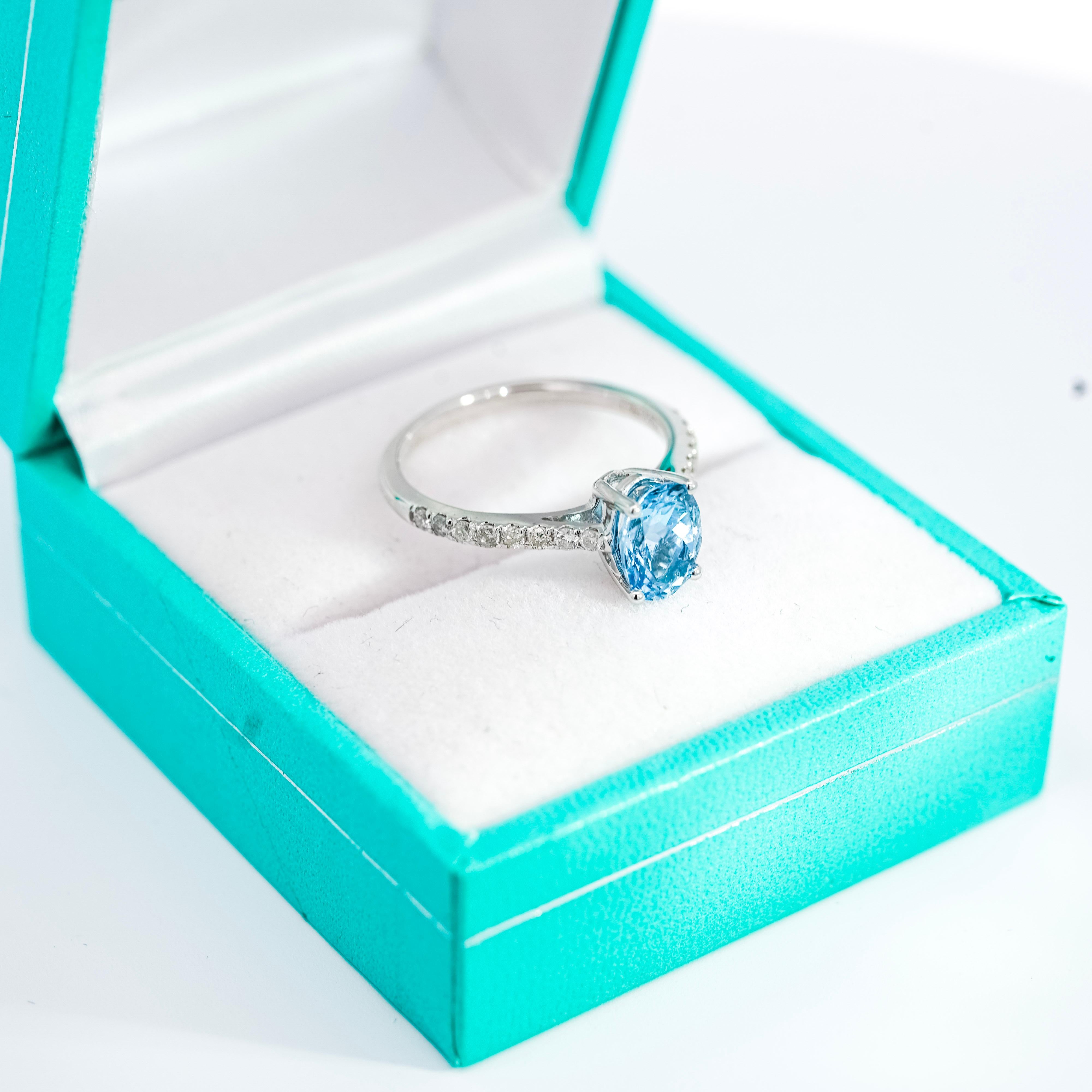 Natural Aquamarine and Diamond Solitaire Ring, Set in 14K Solid White Gold.

This solitaire ring features an oval-cut natural Aquamarine in a prong setting, radiating a vivid blue hue. Paired with round-cut diamond side stones totaling 0.25 carats.