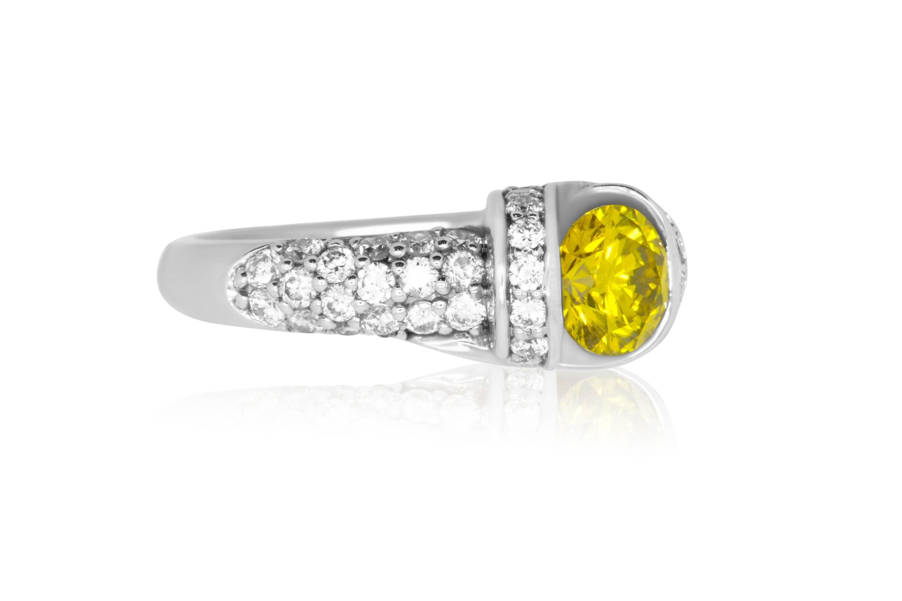 Material: 18k White Gold 
Center Stone Details: 1.16 Carat Round Yellow Diamond
Mounting Diamond Details: 56 White Diamonds at 1.32 Carats - Clarity: SI Color: H-I
Ring Size: Size 6.75 (can be sized)

Fine one-of-a kind craftsmanship meets