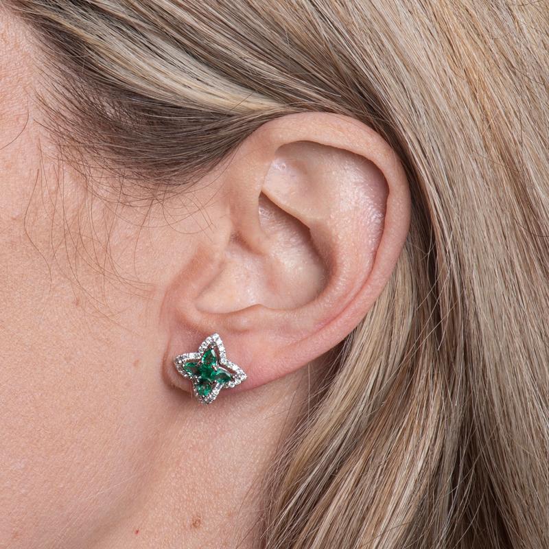 These beautiful stud earrings features 1.16 carat total weight in emeralds accented by 0.46 carat total weight in diamonds set in 18 karat white gold. Friction post with butterfly back. 
Measurements: Circumference approximately 14.45mm