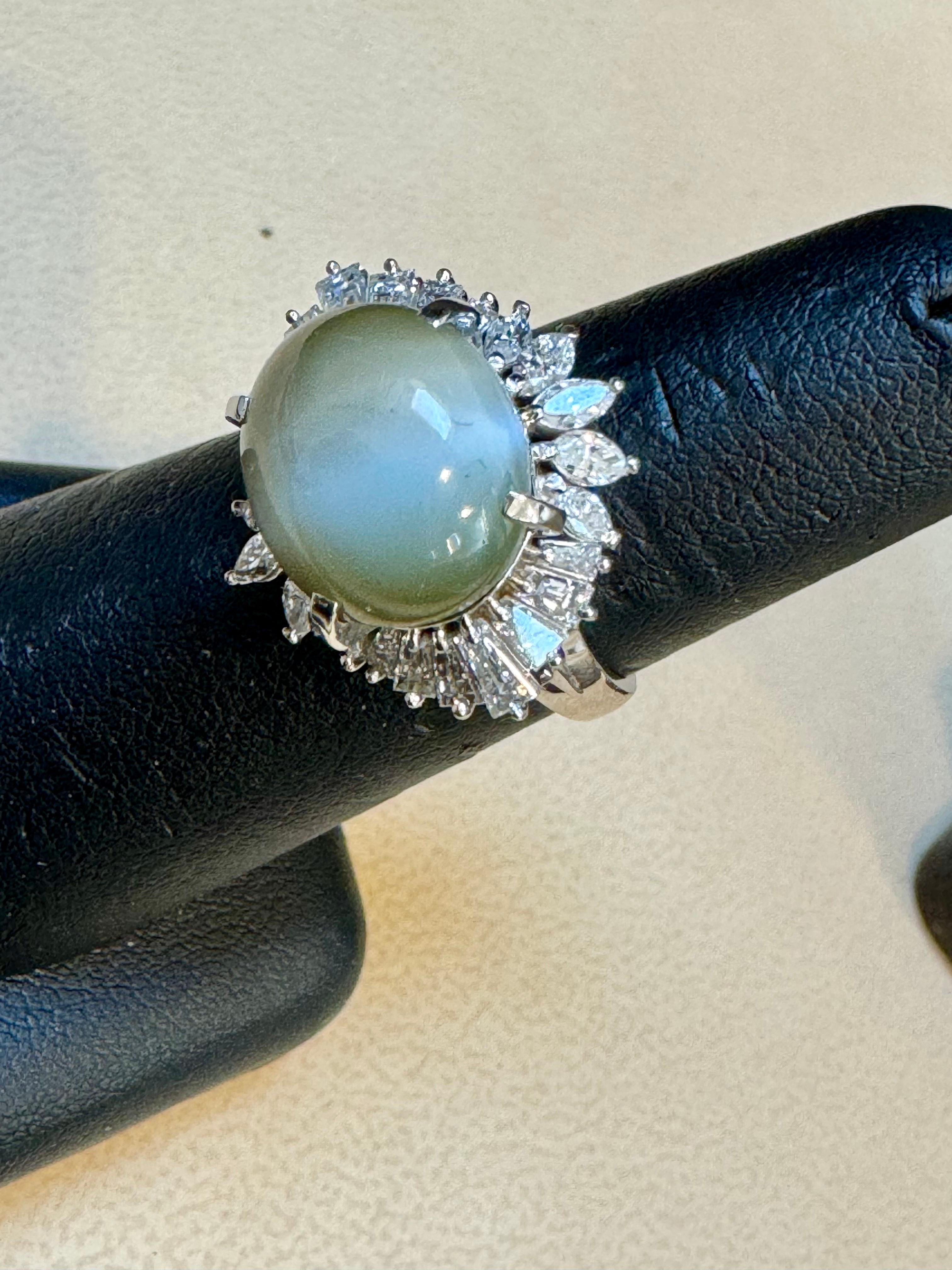 
1970's Platinum And Diamond Ring with 11.54 Carat Chrysoberyl Cats Eye
Ring With Baguette and Marquise  Diamond set in platinum
A large and impressive cats eye chrysoberyl takes center stage. It weighs 11.54 carats and has a strong cats eye (known