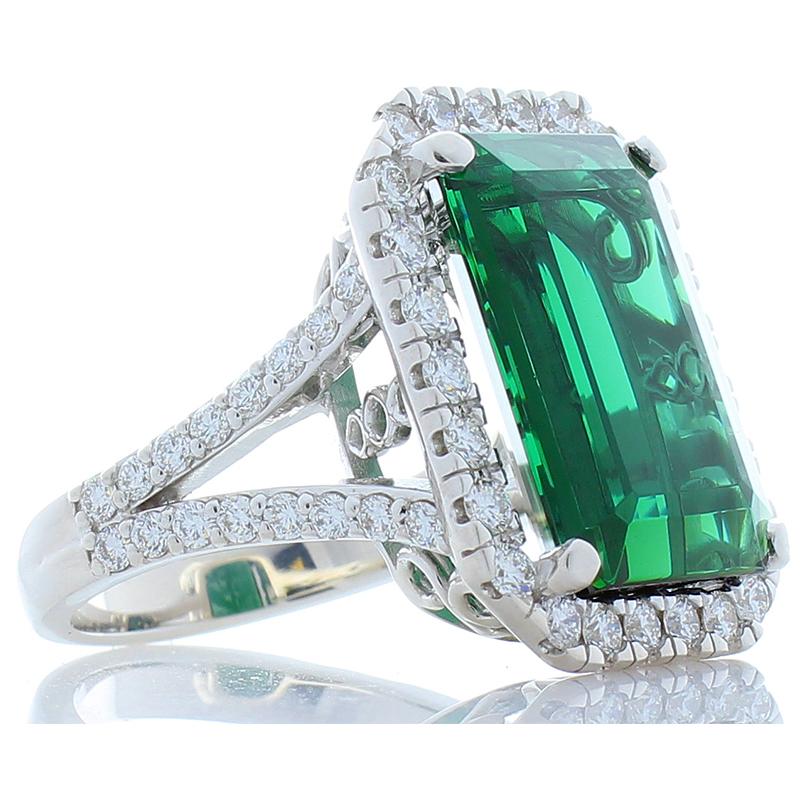 This bold beautiful ring features an 11.61 carat green tourmaline. The cutting style is unique on the crown, emerald cut pavilion. It measures a substantial 11.98 x 16.74 mm. The deep forest and emerald green tones of this gem are accentuated by the