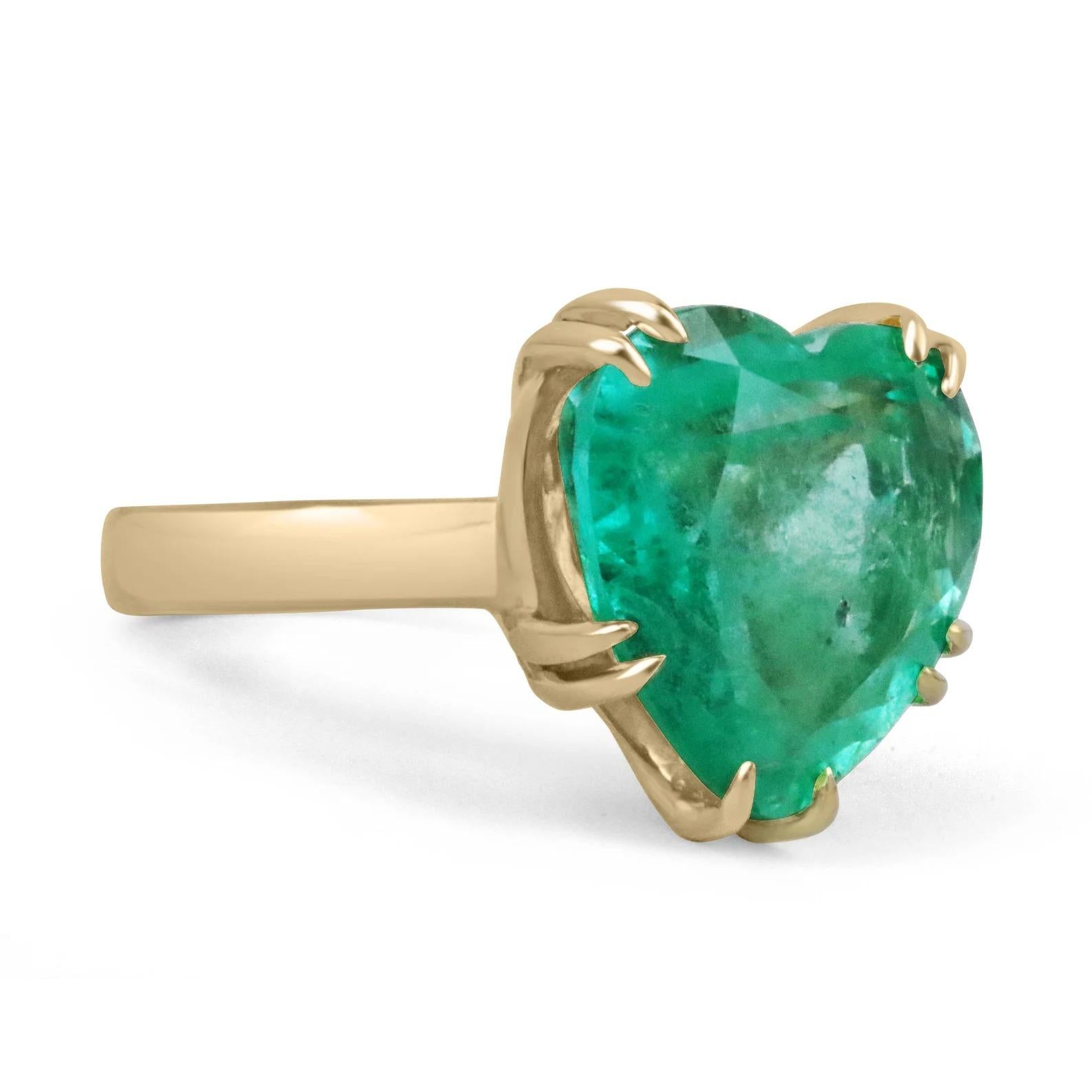 A jaw-dropping emerald solitaire ring. This alluring, and massive piece features a one-of-a-kind, natural 11.62-carat, heart-cut Colombian emerald with the most charming characteristics. The gemstone displays a mesmerizing vivid sea green color,